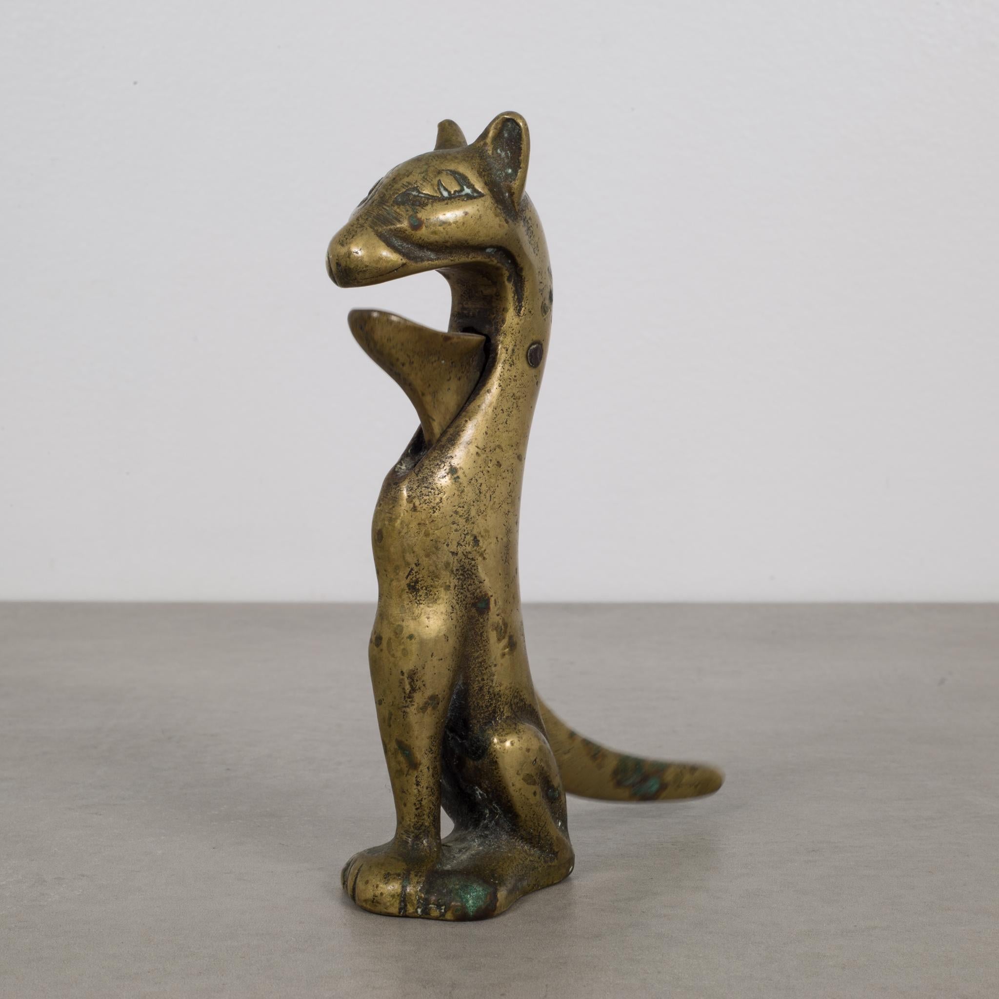 About

This is an original Victorian era solid brass cat nutcracker. The tail opens the mouth for the nut to be cracked and is in good working order. 