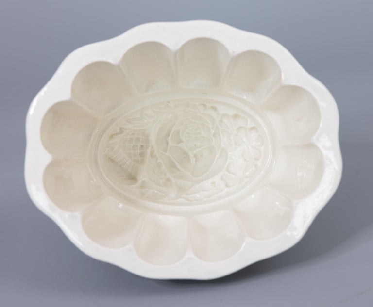 A lovely antique 19th-Century Victorian English white ironstone jelly or pudding mold. Impressed maker's mark for Copeland. This beautiful mold has a rose and thistle design interior and a lovely fluted shape. It would be the perfect addition to