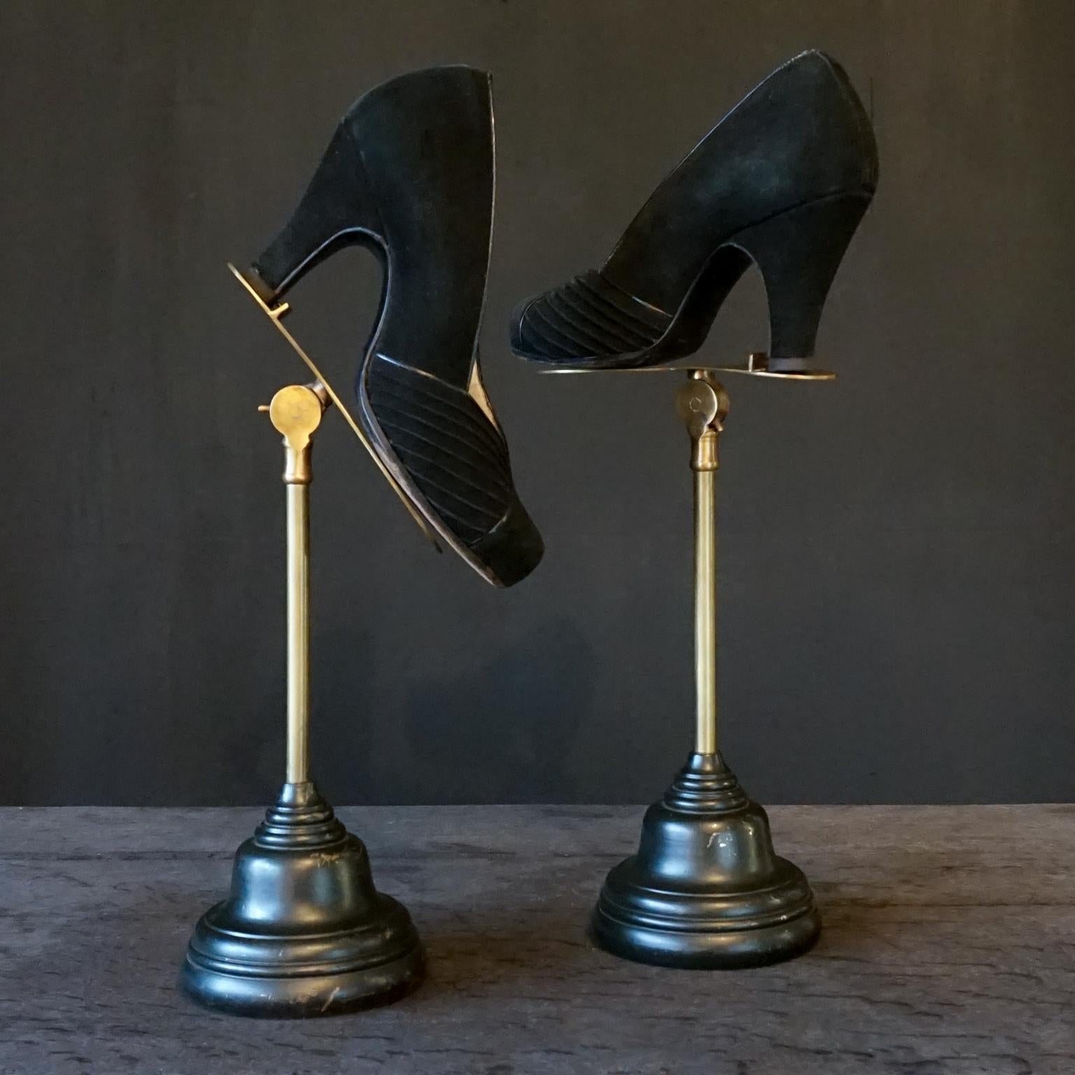 Very pretty set of department store counter display stands for shoes. 
It would be great to display your favourite pair on in your dressing room or walk-in closet.

The stands are adjustable in angle (the shoe shaped brass plateaus), but not in