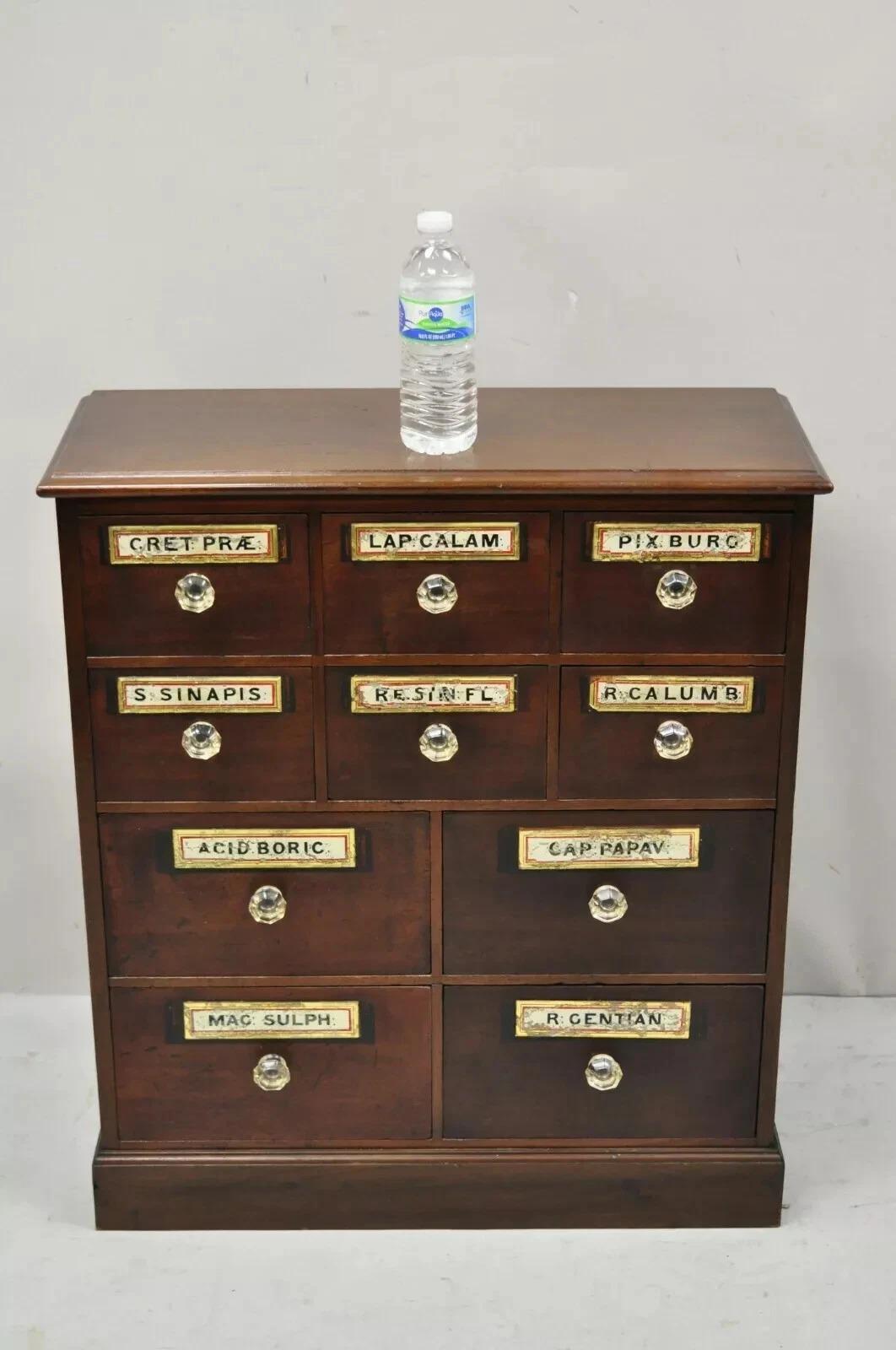 19th C. Victorian Mahogany Apothecary Medicine Cabinet w/ 10 Drawers and Glass Pulls. Item features original glass drawer pulls, glass front eglomise label panels, solid wood construction, beautiful wood grain, 10 dovetailed drawers, very nice