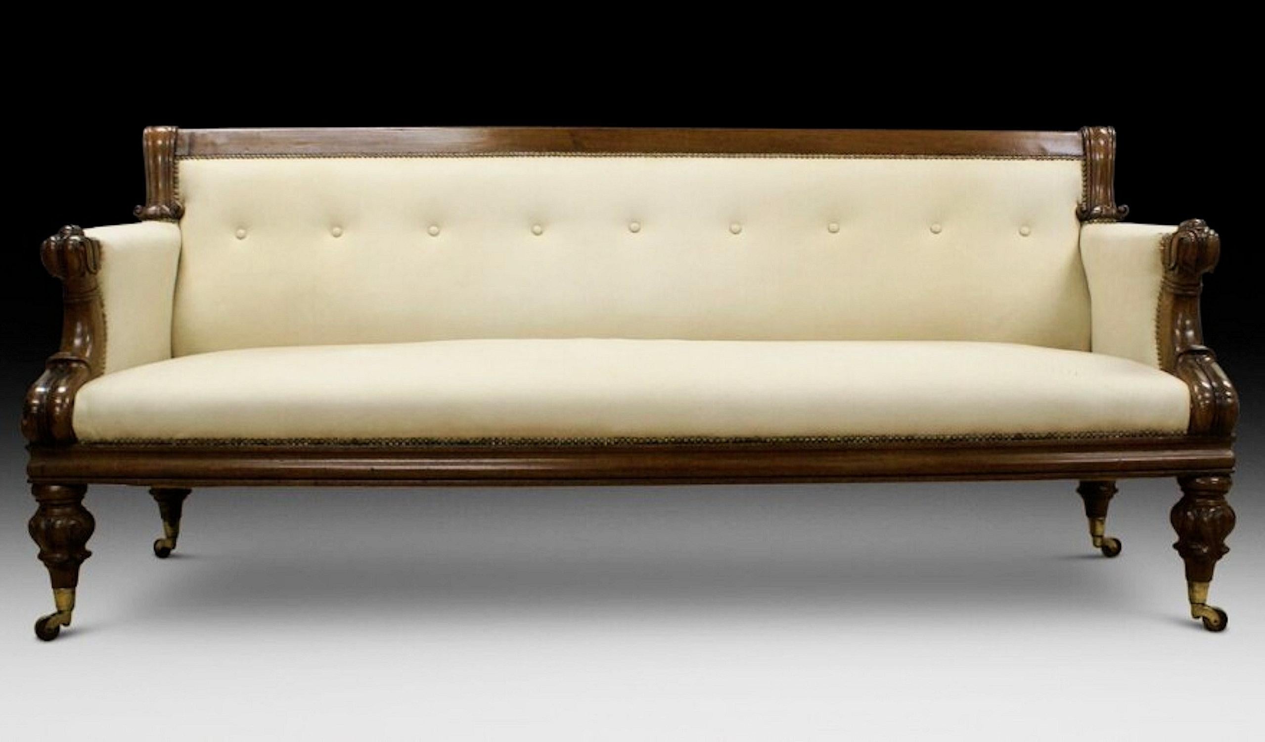 This beautiful and superb quality Victorian sofa is supported on turned and carved legs with brass cup castors and lovely carved arm supports. The sofa has been stylishly upholstered in a cream soft suede with a buttoned back, giving it a much more