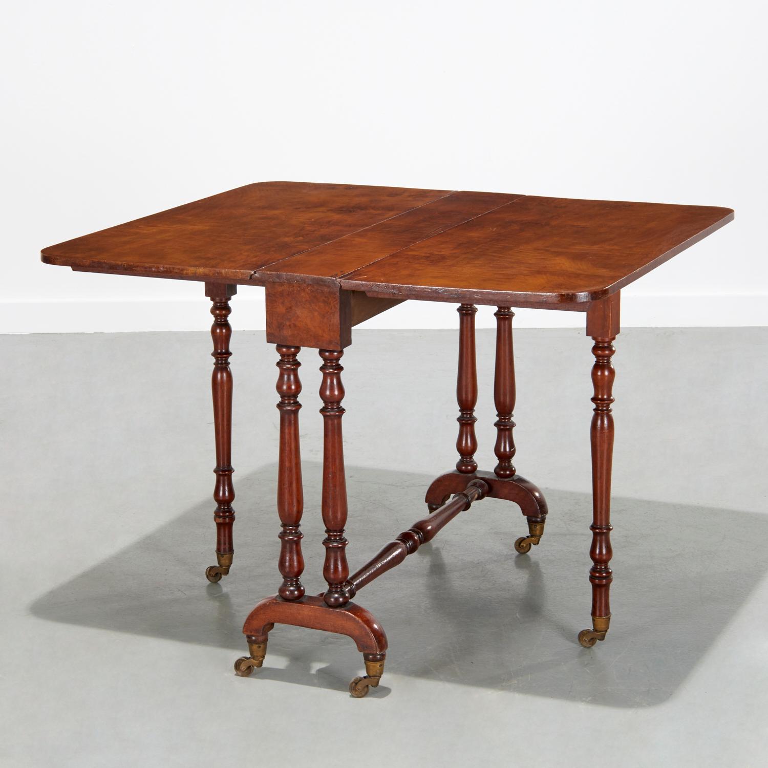19th c. Victorian walnut Sutherland table with two drop leaves. the top is raised on elegant turned baluster legs on original brass casters.

This particular type of drop leaf table, or gate-leg table, is known as a Sutherland table, apparently