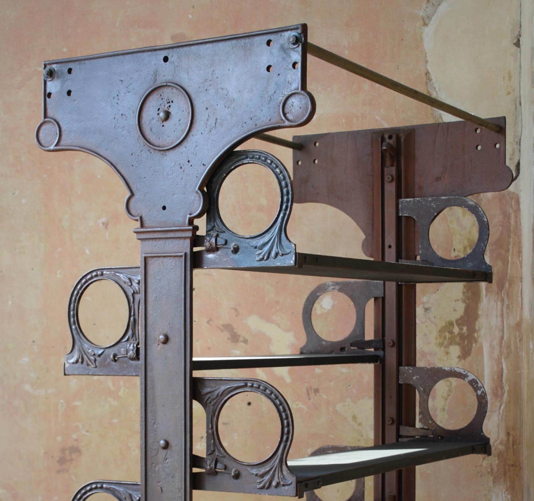A large and fully adjustable set off iron shelving, produced by W.Lucy & Co Ltd towards the end of the 19th century. The company is still in existents today and are still situated in Oxford.

Cast iron with later reclaimed wooden shelves, each