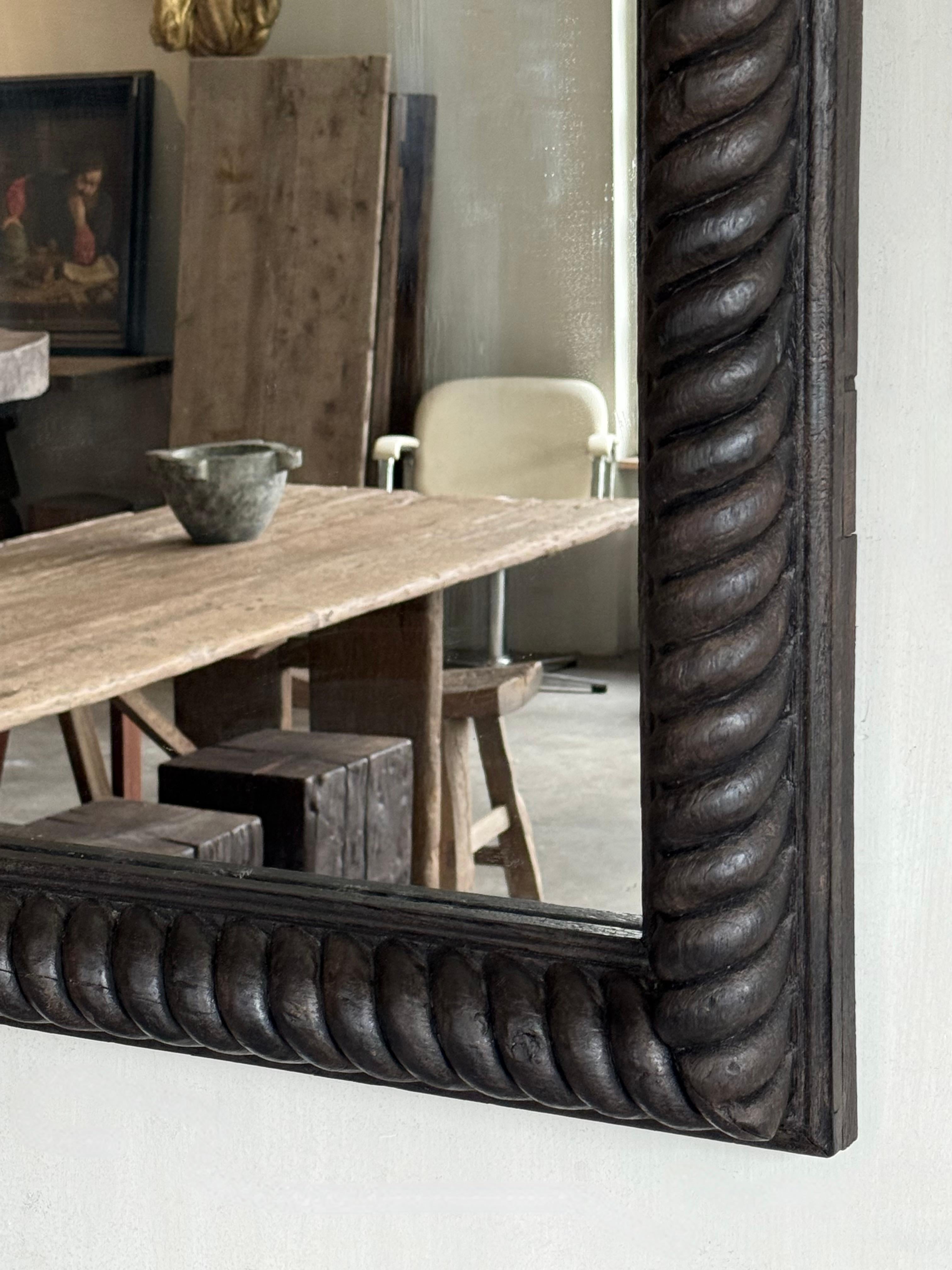 Beautiful old 19th C Belgian mirror.

Carved from walnut wood in a twisted pattern.
Over the years, the mirror glass has been replaced, making it clear and perfectly usable. This intricate craftsmanship also has a pure simplicity.

A timeless piece
