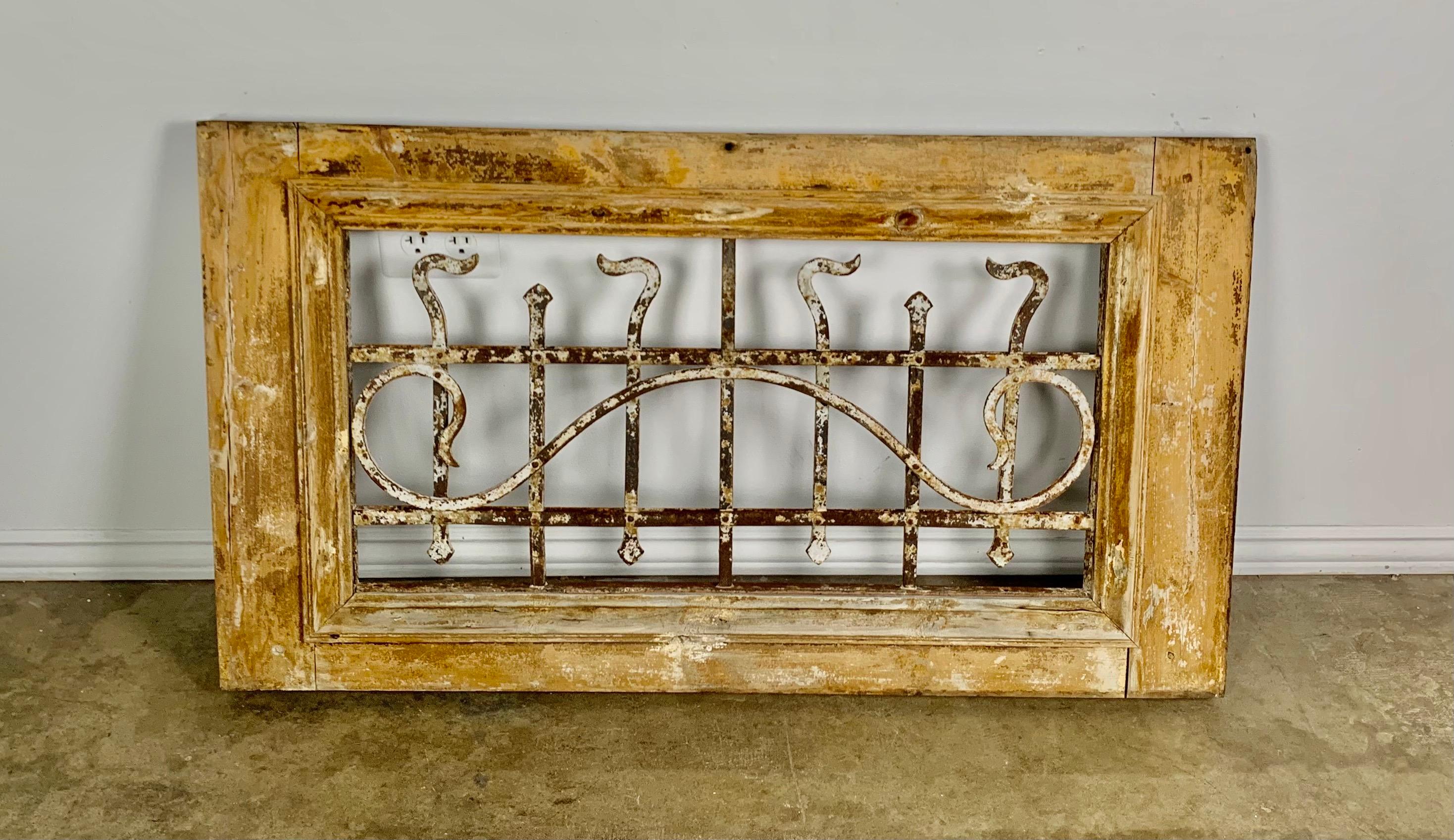 19th century panel made of a wood frame with hand wrought iron inset. Beautiful distressed paint throughout. It would be great to build into a construction project or incorporate as interesting wall decor.