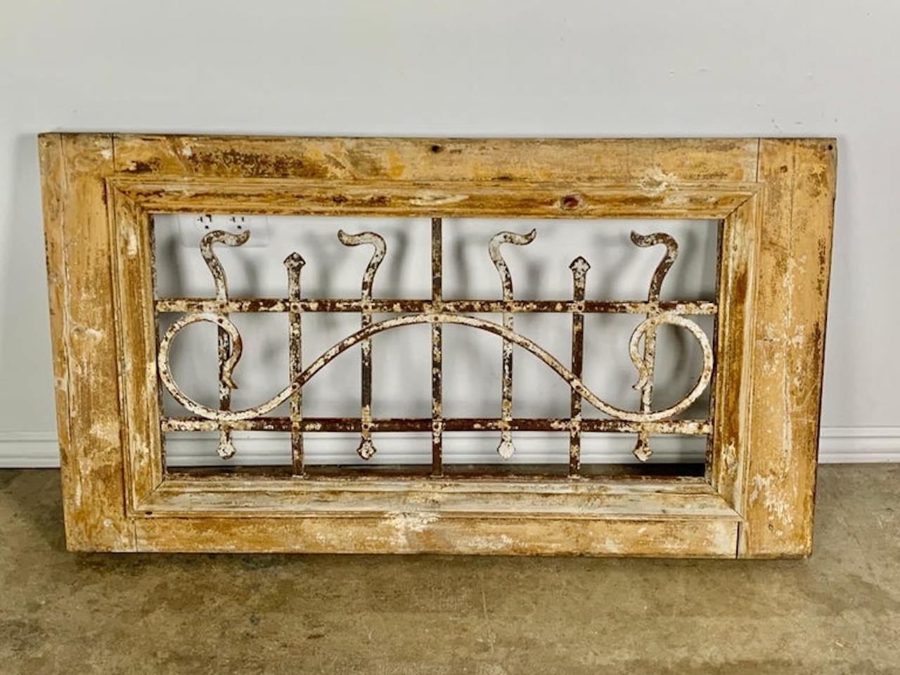 19th century panel made of a wood frame with hand wrought iron inset. Beautiful distressed paint throughout. It would be great to build into a construction project or incorporate as interesting wall decor.