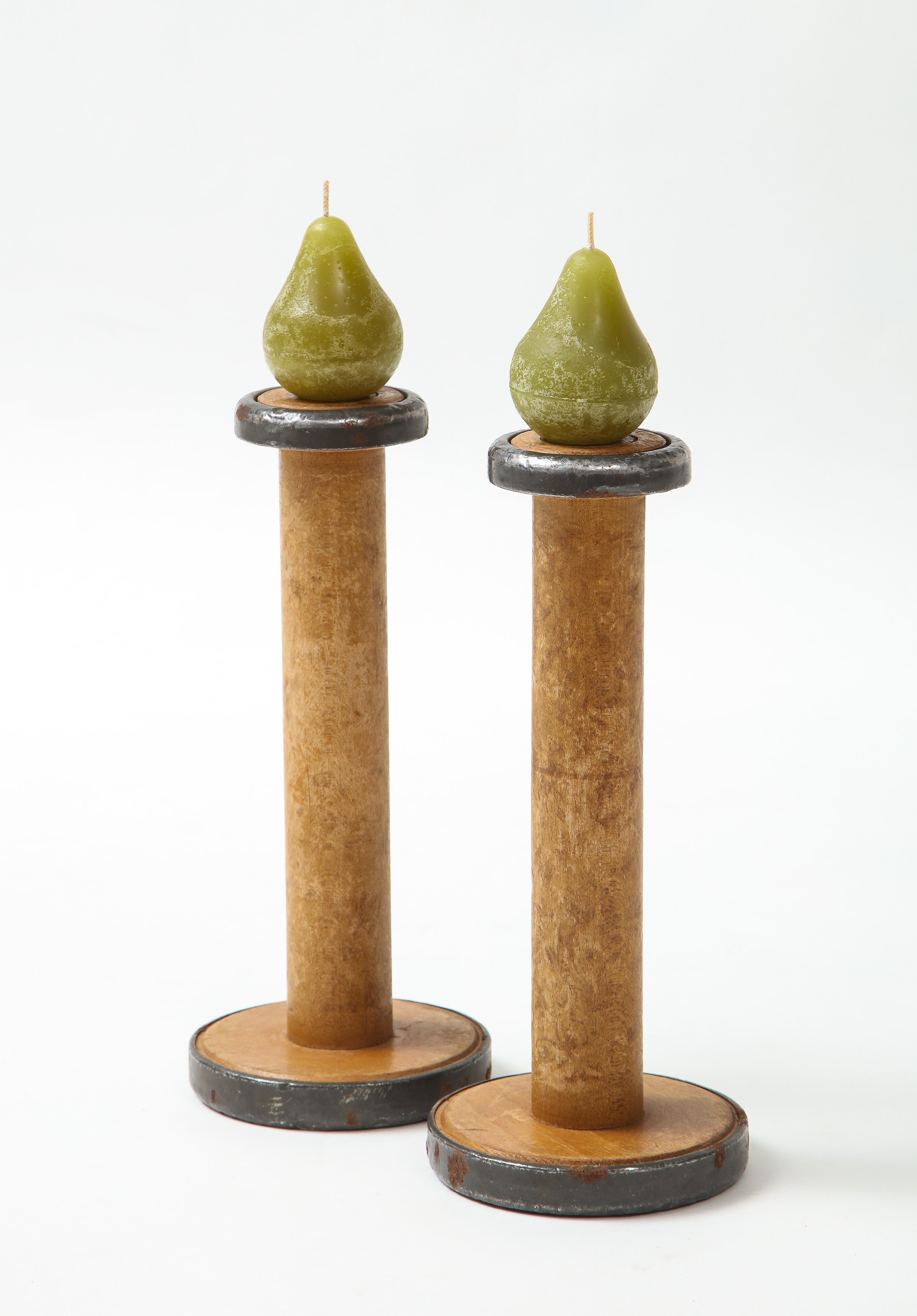 Pair of Industrial 19th century wooden spool candlesticks with hand poured pear candles.