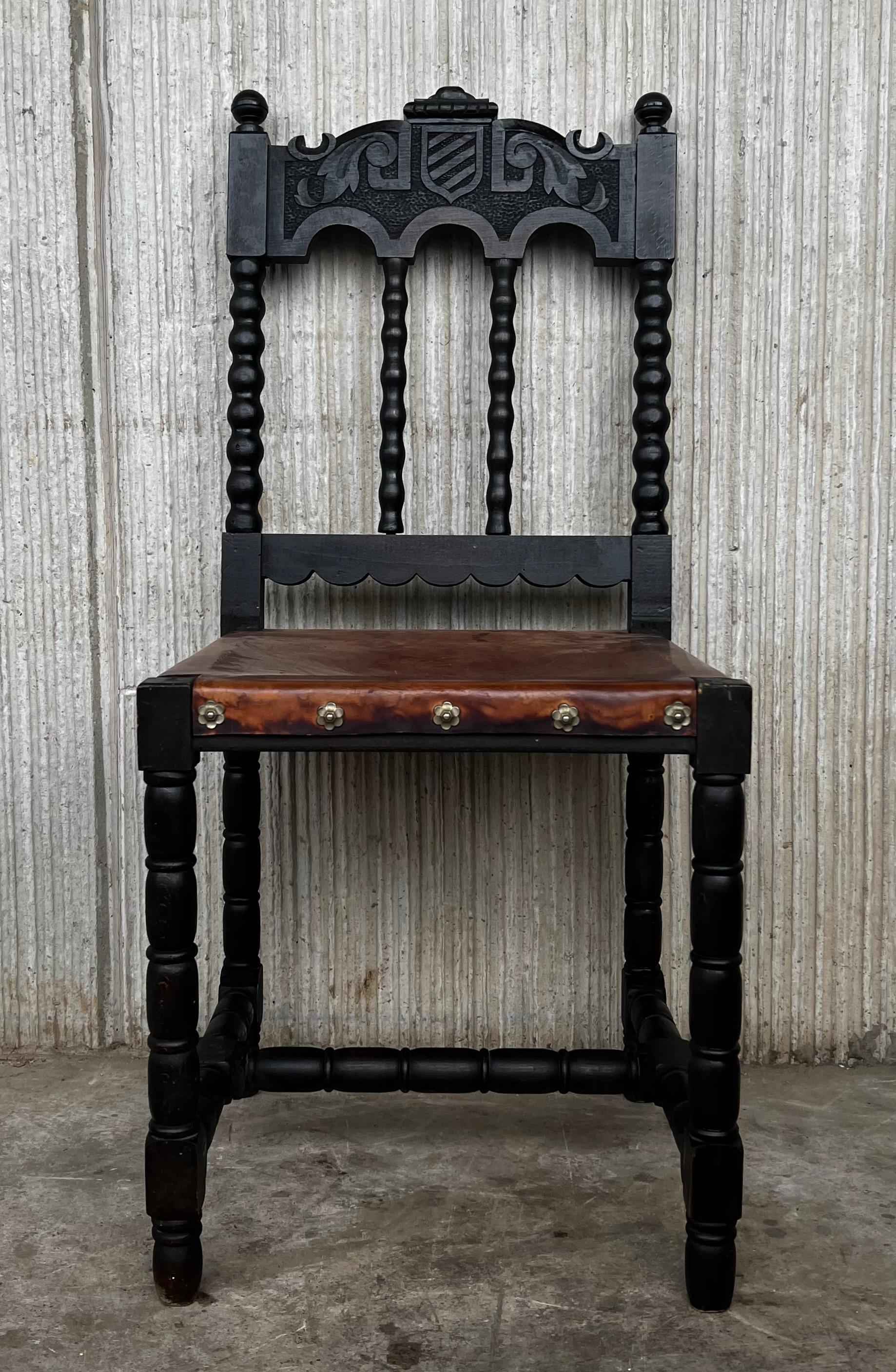A set of 6 Spanish chairs with leather sling seatsand backs on oak and sycamore frames with hand carved decoration. These chairs are true to the Baroque Spanish character and each features carvings that employ typical Spanish elements . The leather