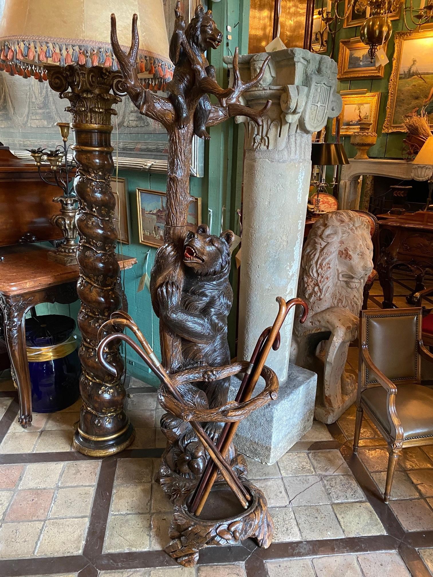 Exceptional and Large 19th century very beautifully carved wood black forest bear hall tree Umbrella Stand with the large standing Mama bear , mouth open and glass eyes watching her cub above as if with a smile , on a naturalistic base Fitted with