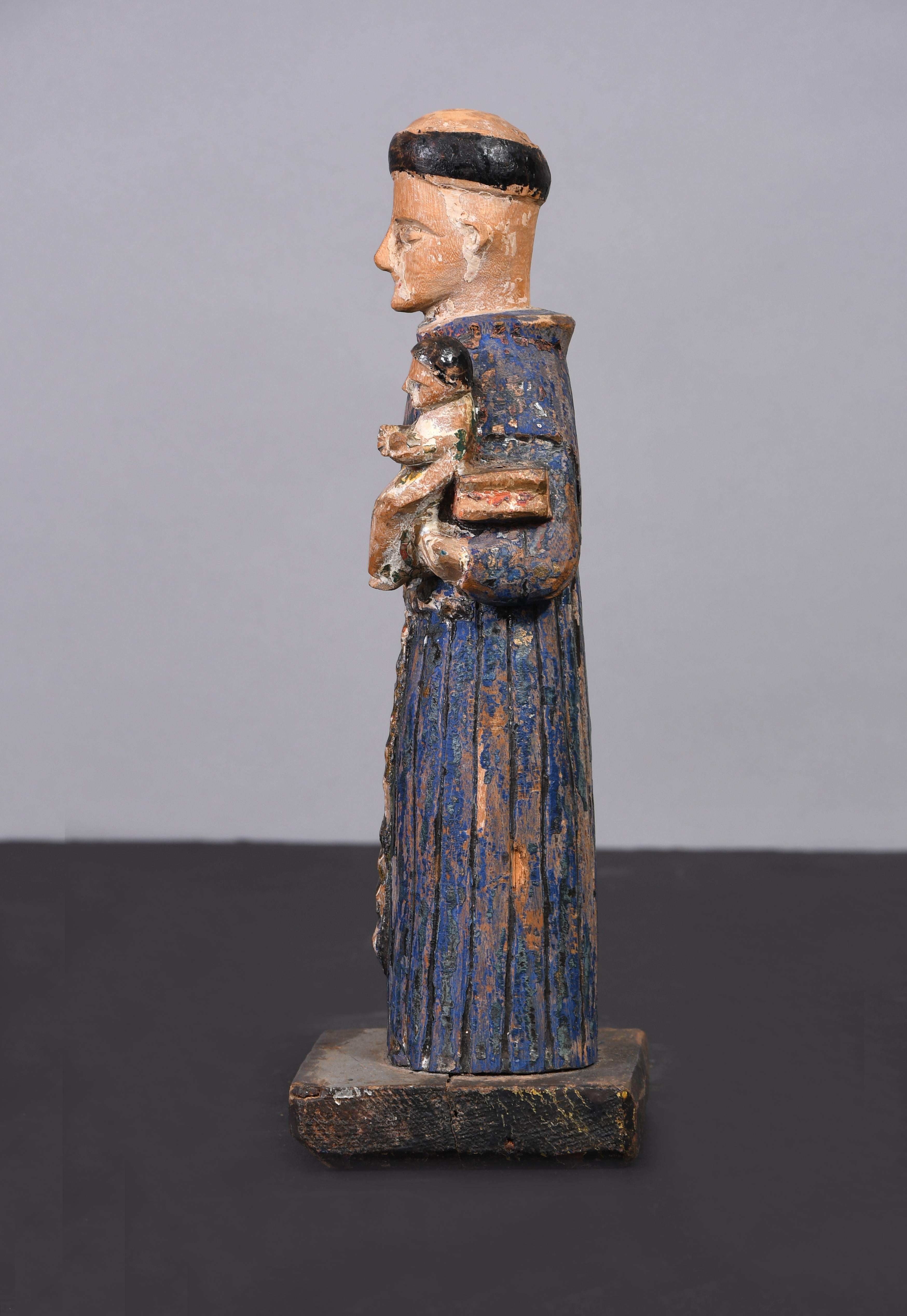 Antique carved sculpture of San Antonio made in Puerto Rico by re-known wood carver from Mayaguez, Pepe Ramos. The saint is dressed with a typical Franciscan order blue cassock and rope. It can be admire the reeded work of the rope and the bottom