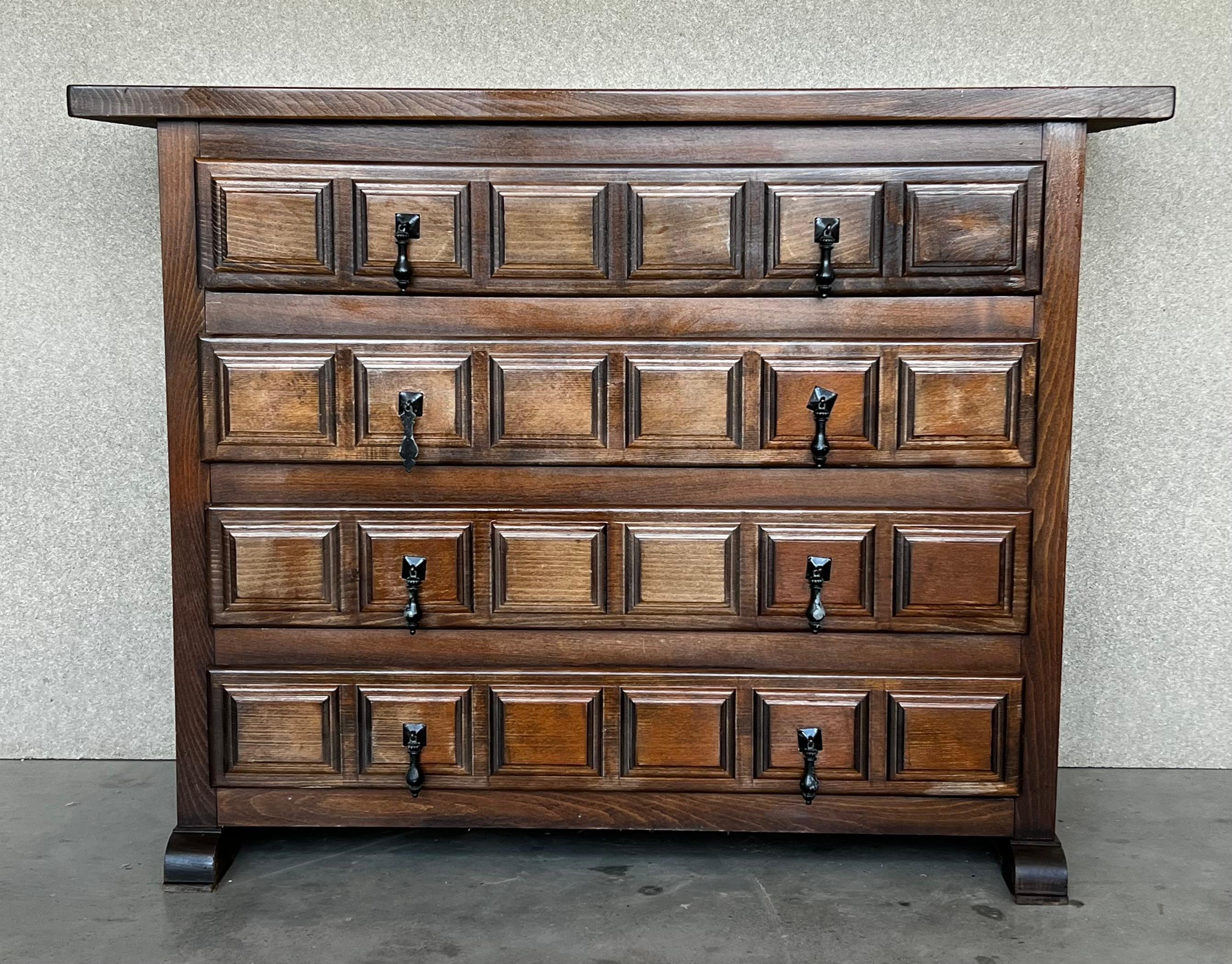 From Northern Spain, constructed of solid walnut, the rectangular top with molded edge atop a conforming case housing four drawers paneled with solid walnut, raised on pedestal legs.
Carved on the molding sides of the front and original iron