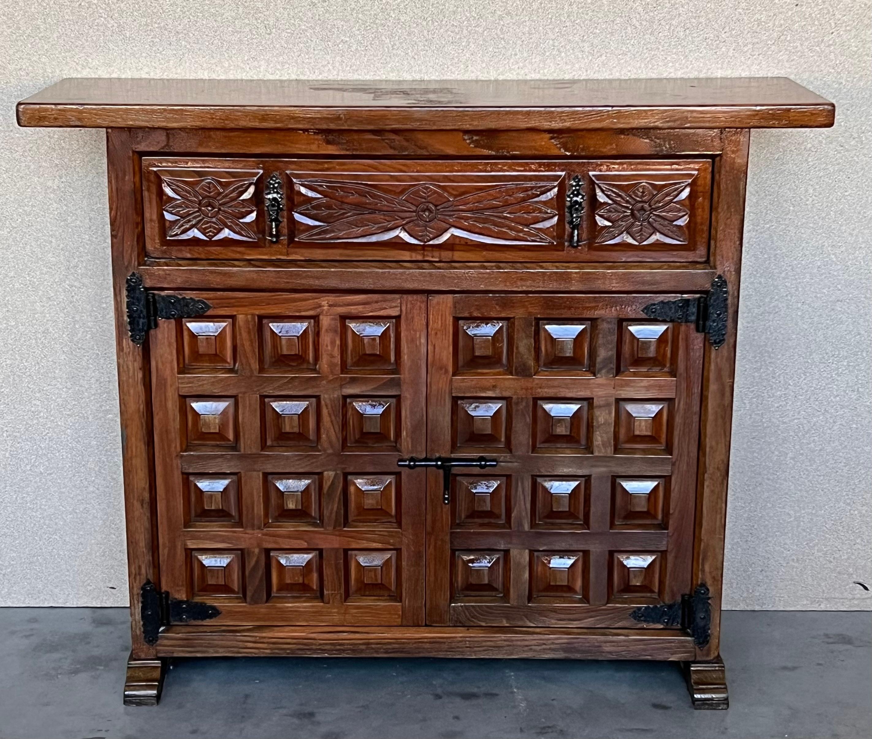 From Northern Spain, constructed of solid walnut, the rectangular top with molded edge atop a conforming case housing one drawer over two doors, the doors paneled with solid walnut, raised on a plinth base.


This vintage item has no defects, but