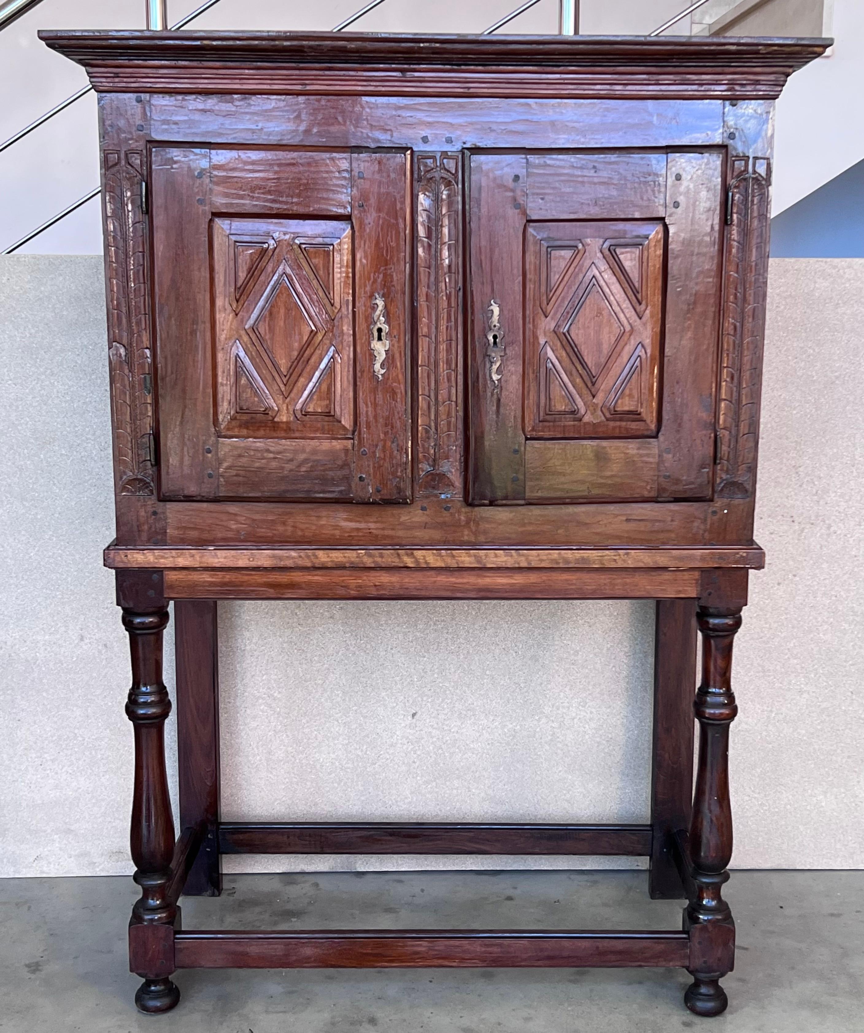 19th Catalan Spanish cabinet on stand in carved walnut with two doors in the cabinet. 

