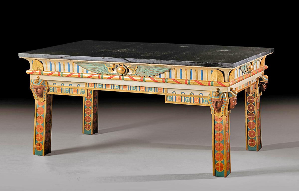 19th century carved parcel-gilt polychrome painted center table in the taste of Ancient Egypt, circa 1867-1870.
The top of the table is an original black Belgian marble top.
Supplied to Khedive  Ismail Pacha for his Gezireh palace in Cairo, for the