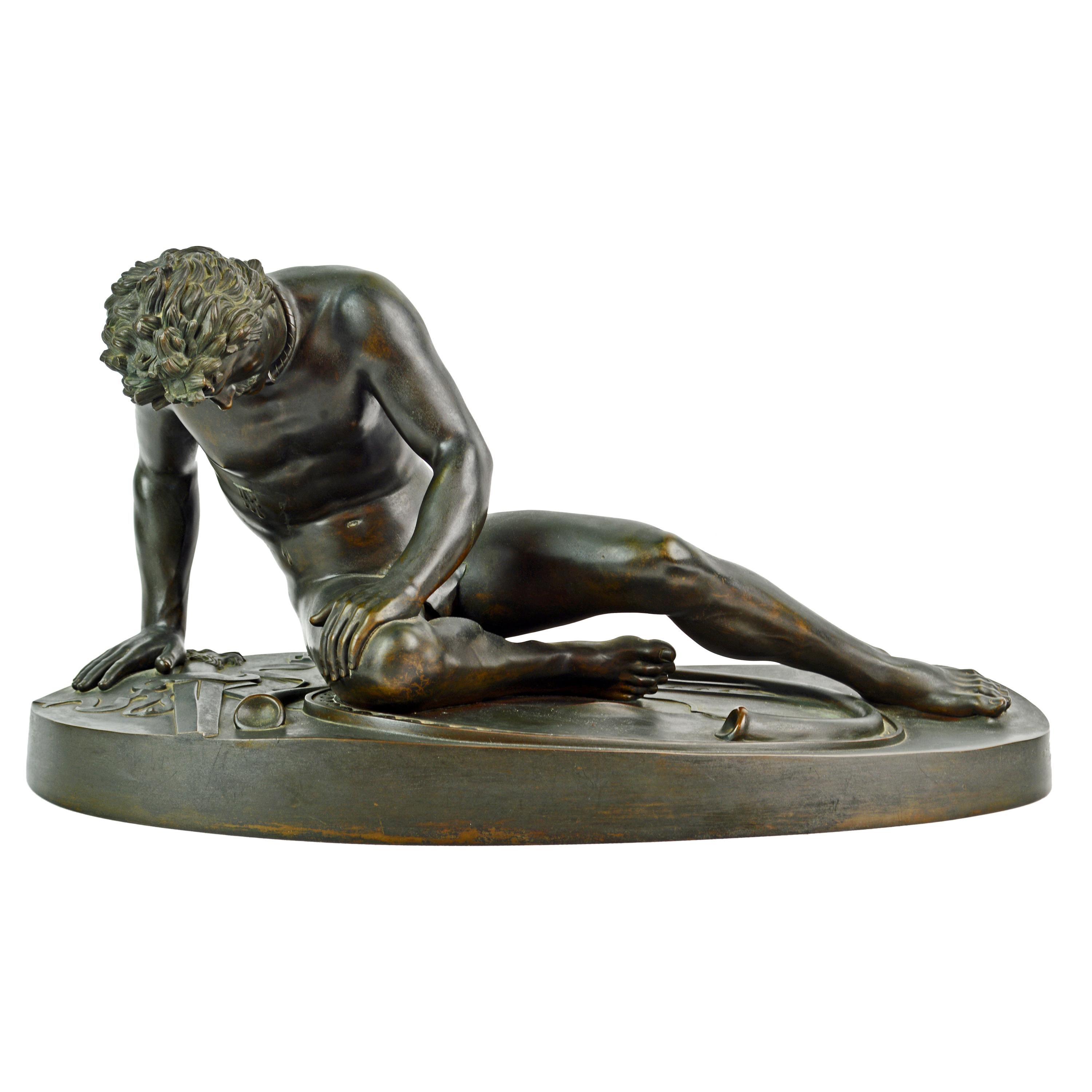 28 inches long and 12 inches tall this mid-19th century patinated bronze statue of the Dying Gaul by Benedetto Boschetti (1820-1870) after the antique is an impressive sight. The Dying Gaul is an Ancient Roman marble copy of a lost Hellenistic