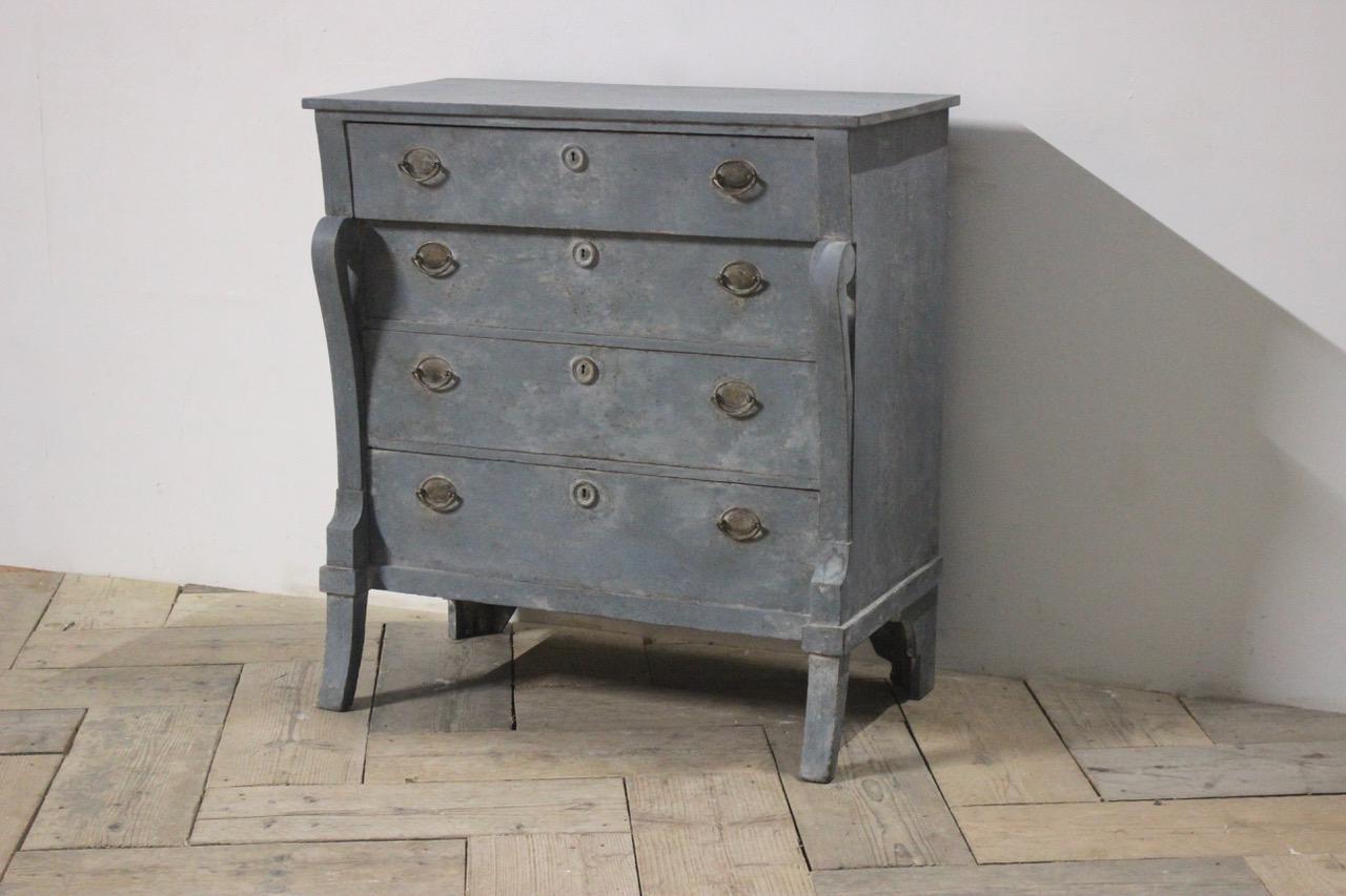 An early 19th century Dutch concave commode with scroll supports, of small proportions with later distressed paint.
 