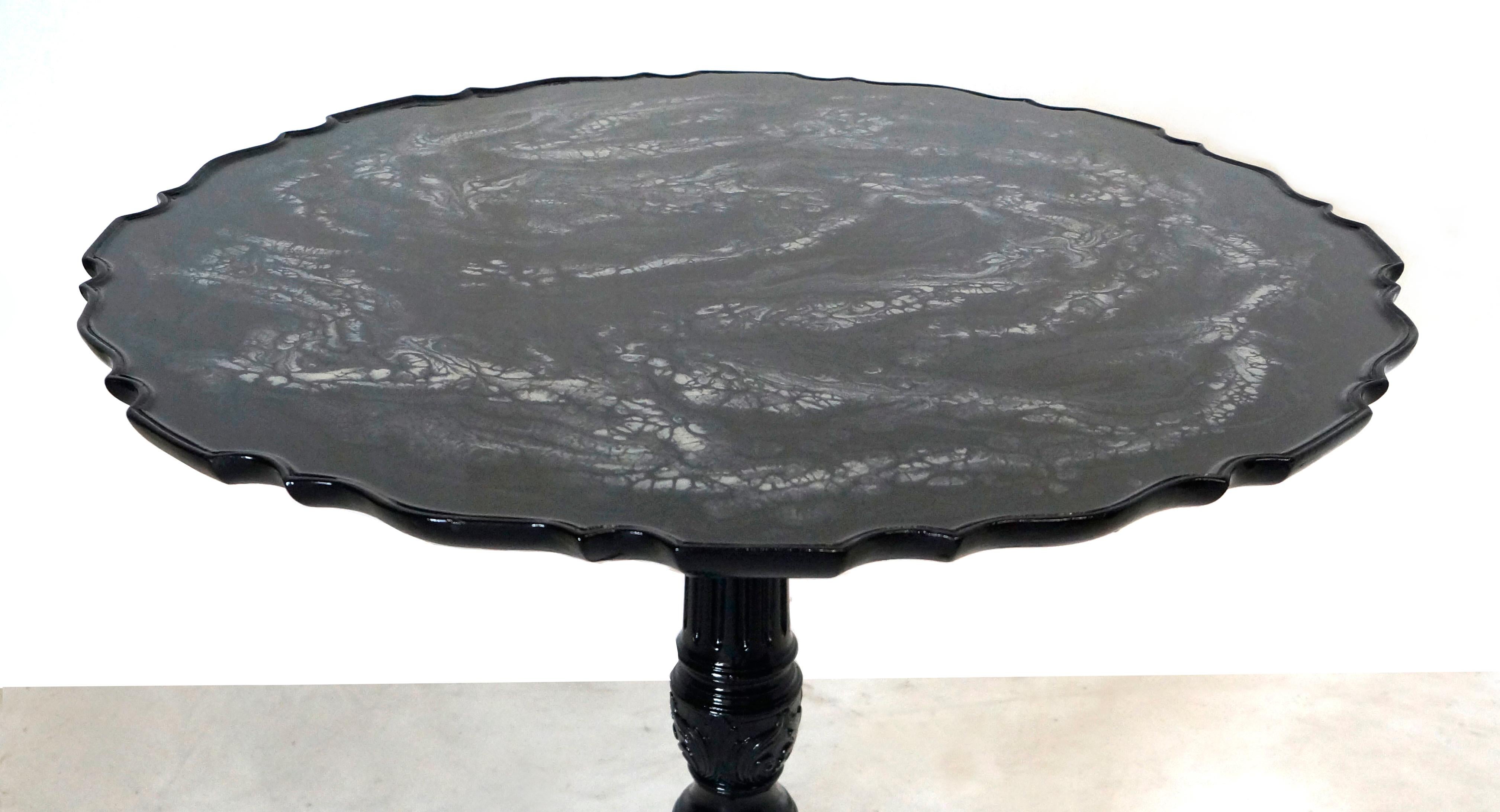 Original English 19th century gueridon customized with a black and silver resin coat on the top. Original hand carved, the base is lacquered in black.
Contemporary finish for this antique piece.