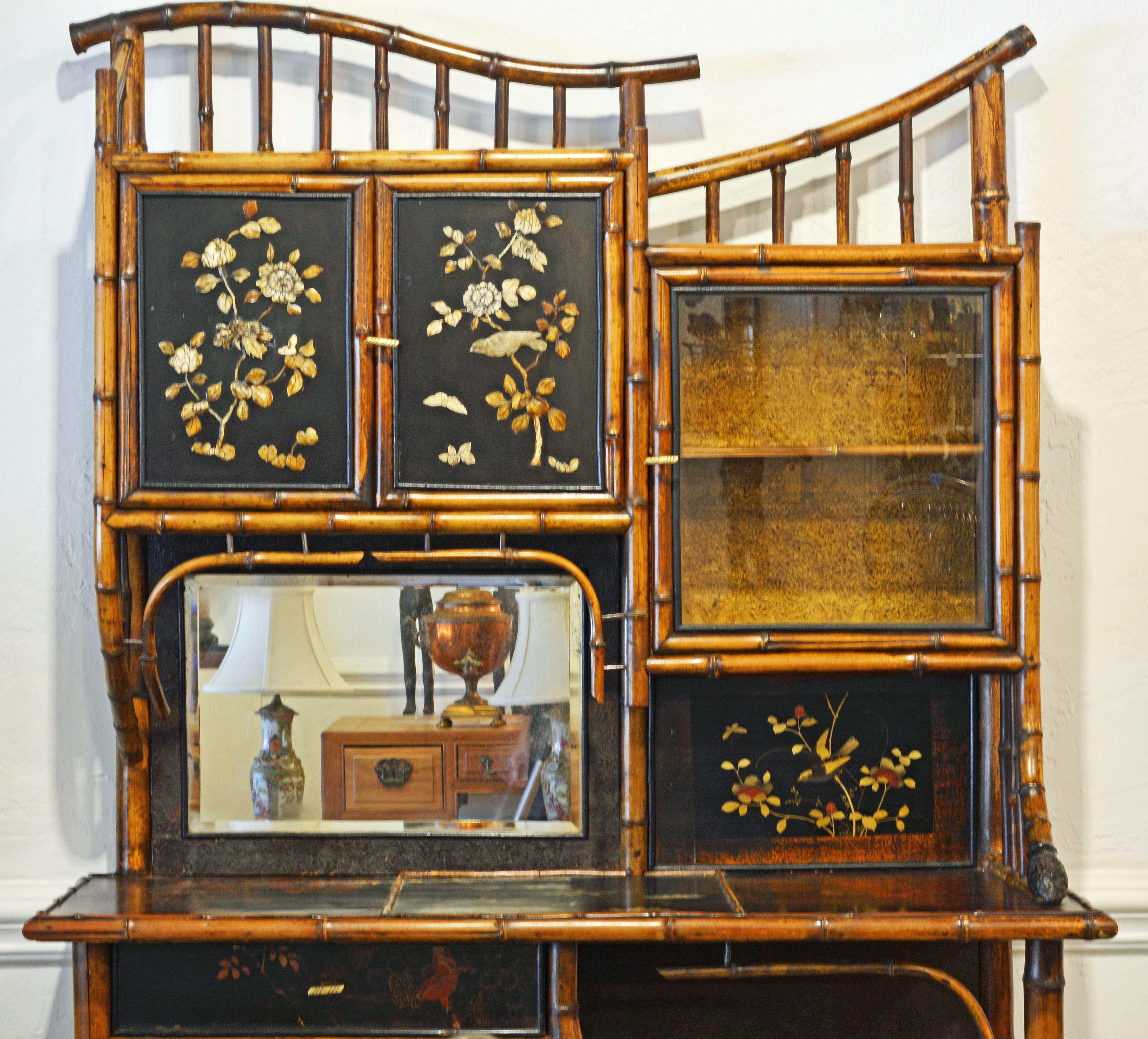 A wonderful English Burnished bamboo framework incorporating two cabinets with japanned lacquer doors and two cabinets with glass doors as well as a decorated table surface and open shelf compartments. Quite unique and elaborated in the manner of