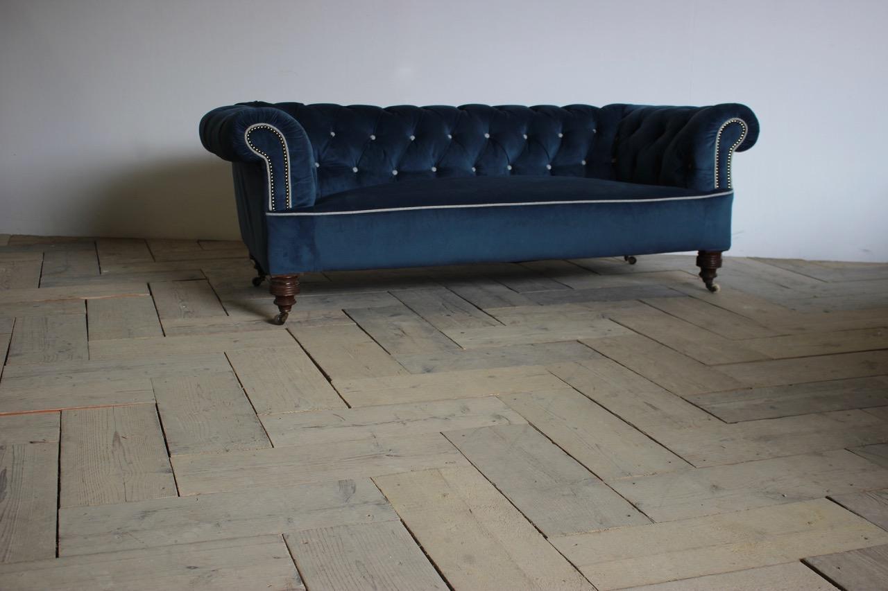 19th century English Chesterfield on four turned legs with castors, having been recently reupholstered by us in a blue velvet with grey piping contrast. 

England 

Measurements: 38cm High (floor top seat) 
.