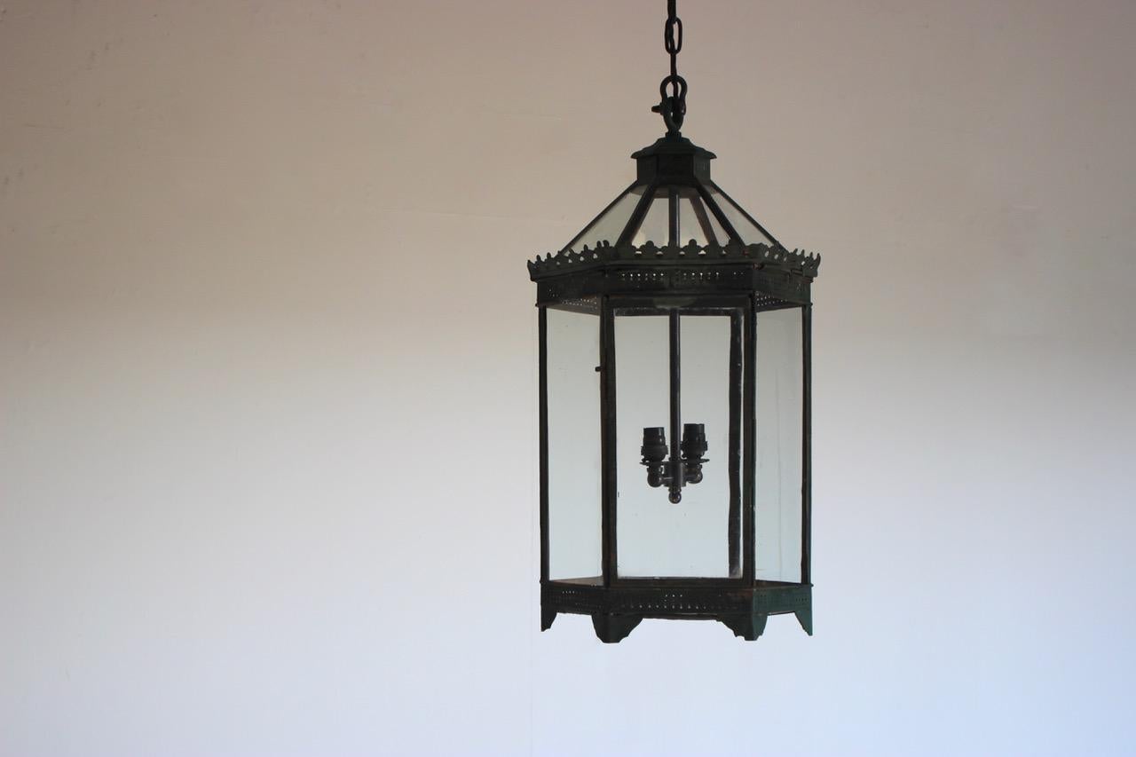 A mid-19th century English country house Toleware lantern recently rewired for the UK market with the original glass.
 