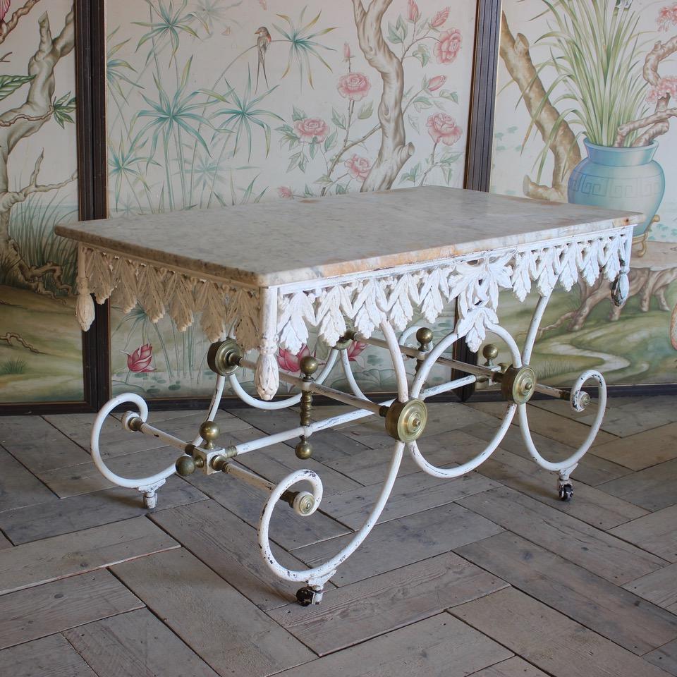 A great quality and retaining its original marble, 19th century French Patisserie table of elegant proportions, in painted cast iron with brass details, that will make a statement in most settings.
Original cast iron wheels.
France, circa 1870.