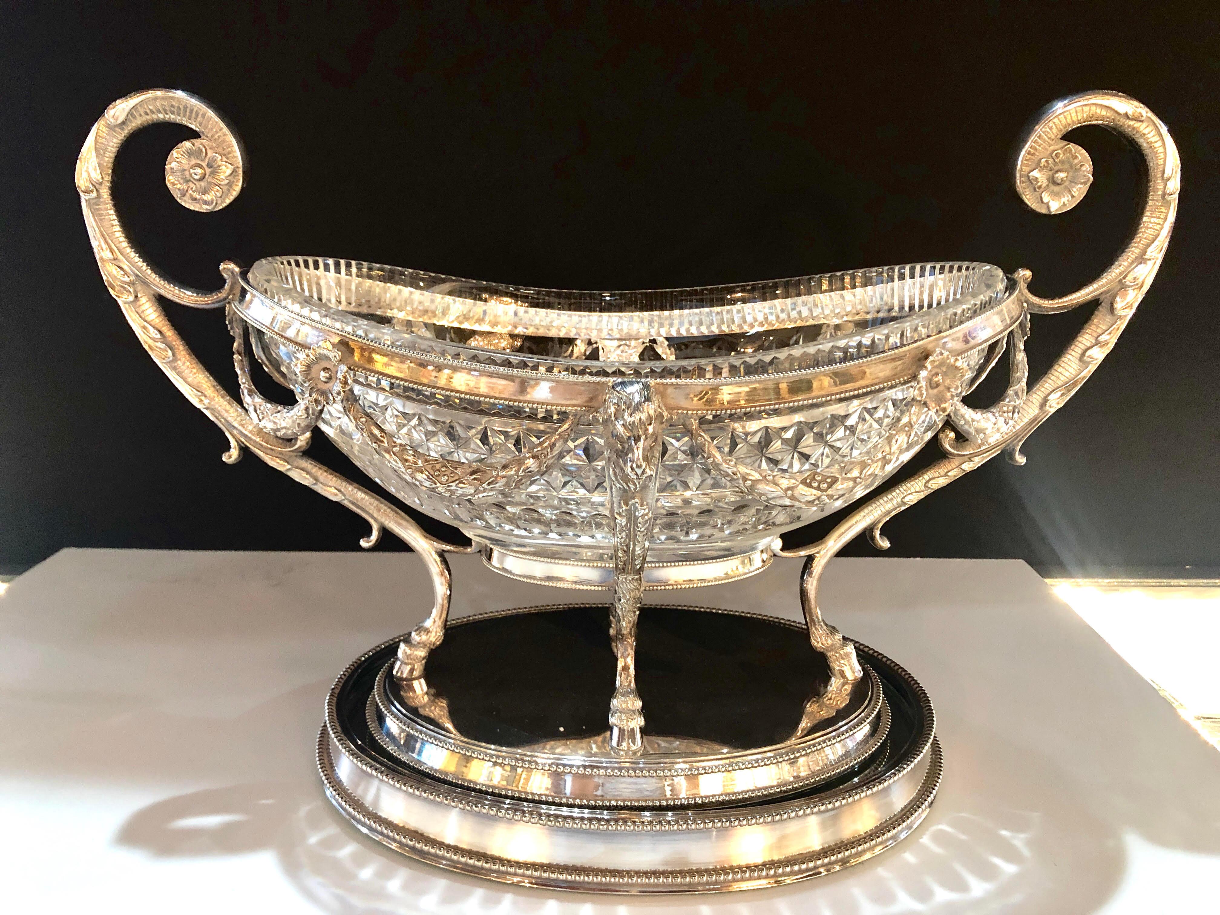 Spectacular 19th century George III style silver plated oval center bowl with cut glass liner on a mirrored plated tray. This large and impressive center piece has solid and sturdy handles supporting a center apron depicting rams horned busts