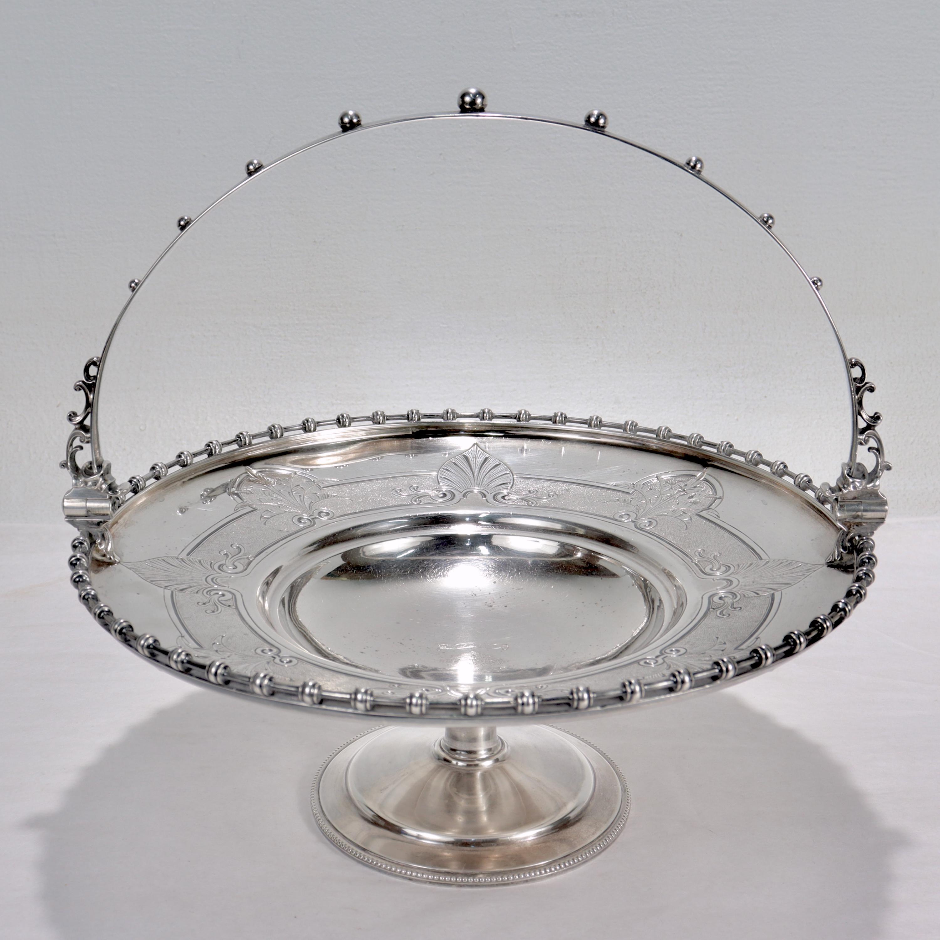 A very fine 19th century tazza of Southern interest.

In coin silver by Gorham Manufacturing Co.

The tazza having a sturdy swing handle set with graduated spheres, a pierced gallery rim, a wide border with etched anthemion devices, and a center