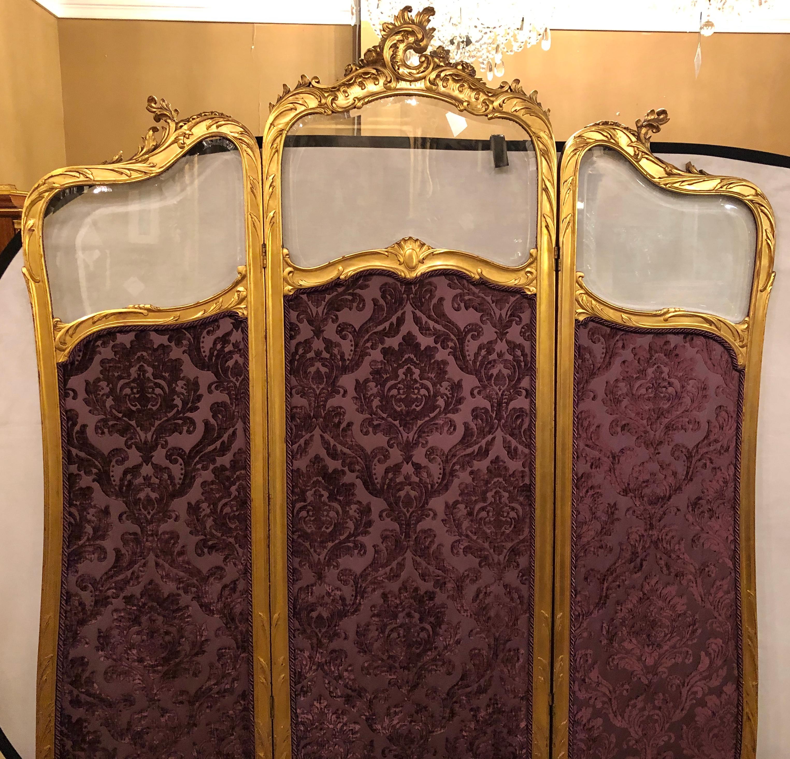 Fine Louis XV style giltwood three fold screen with original glass panels newly upholstered in a cut velvet amethyst color fabric, French, 19th century.


SXX