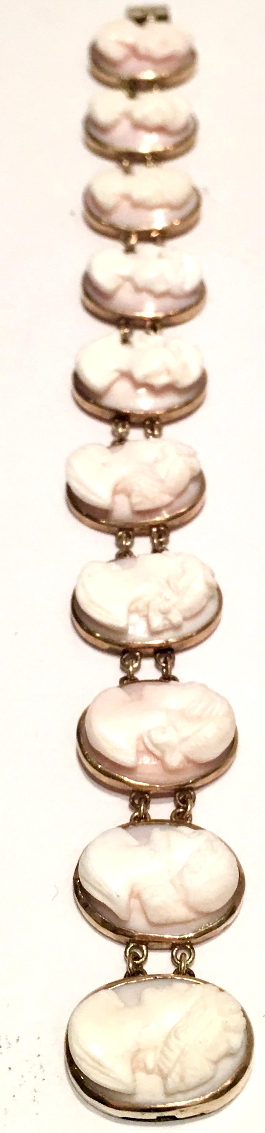 Fine Italian 19th Century La Belle Époque Period 12-karat gold set ten panel finely hand carved high relief pink and white shell cameo bracelet. Features 10 cameo charms,  five left and five right facing female portrait. Each of the ten panels