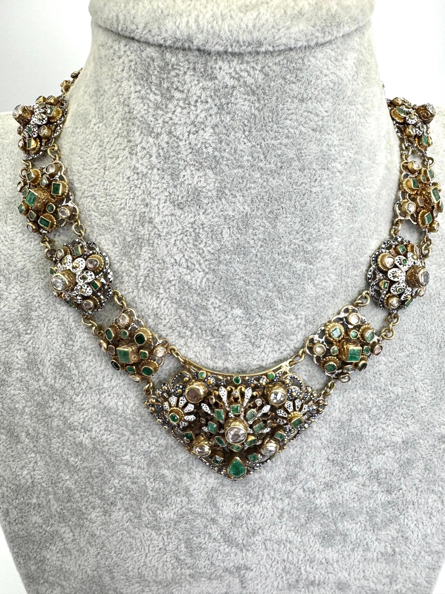 A rare 19th-century Austrian necklace handcrafted in a combination of 14k and 18k gold. This elegant antique treasure features 69 rose-cut diamonds and vibrant emeralds, delicately accented with fine enamel work. A true example of 19th-century