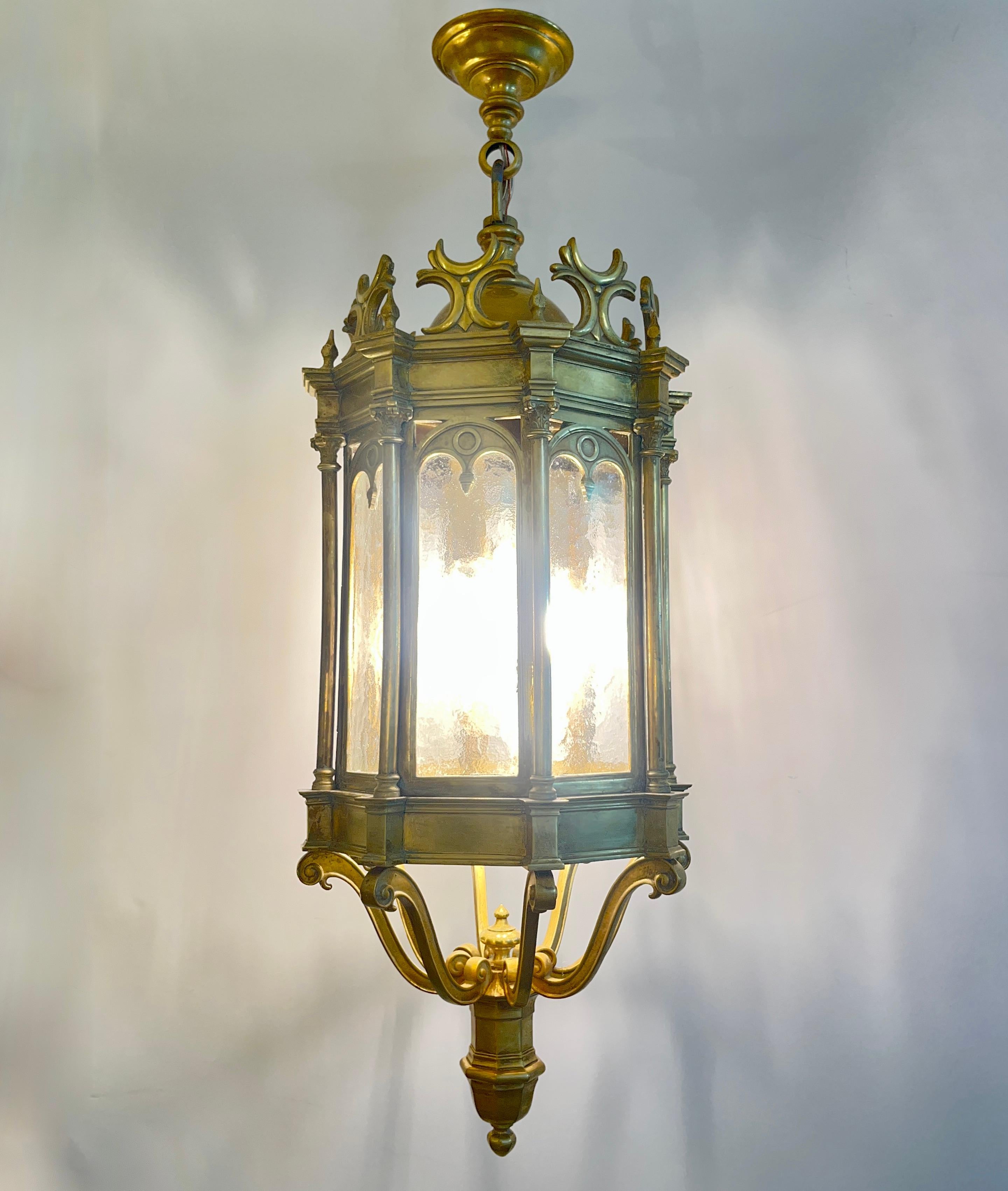 Superb quality, French Gothic Revival pendant lantern dating to around 1860, exquisitely handcrafted in heavy cast bronze. This rare piece showcases remarkable chasing and architectural detail, with eight arched panels of hand-hammered textured