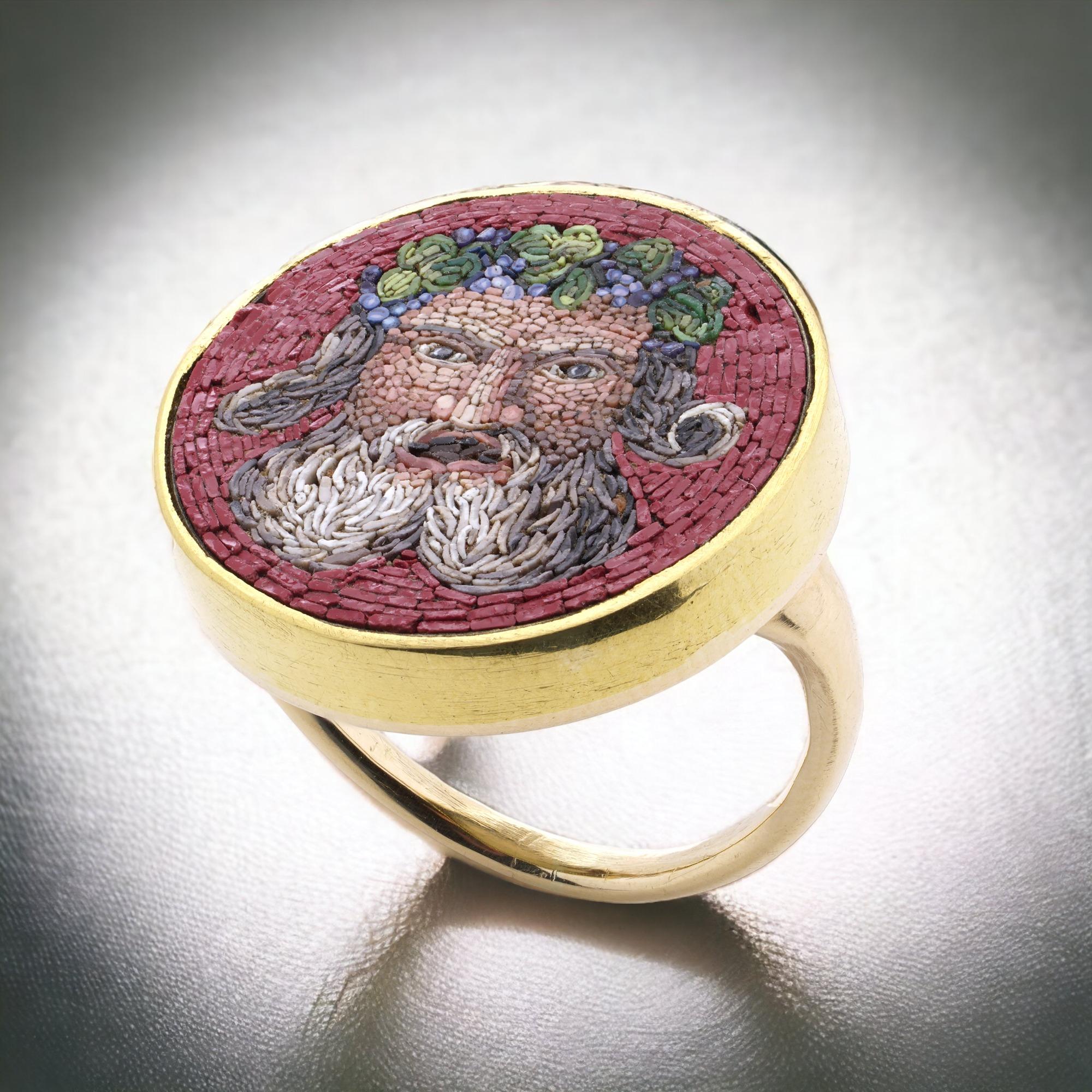 19th Century 18kt. yellow gold micro mosaic ring, featuring a Bacchus head. 
Made in Italy. 
 X-ray has been tested for 18kt. gold. 

The dimensions - 
Ring Size: Length x Width x depth: 2.7 x 2.2 x 2.3 cm 
Finger Size (UK) = M (EU) =54 (US) =