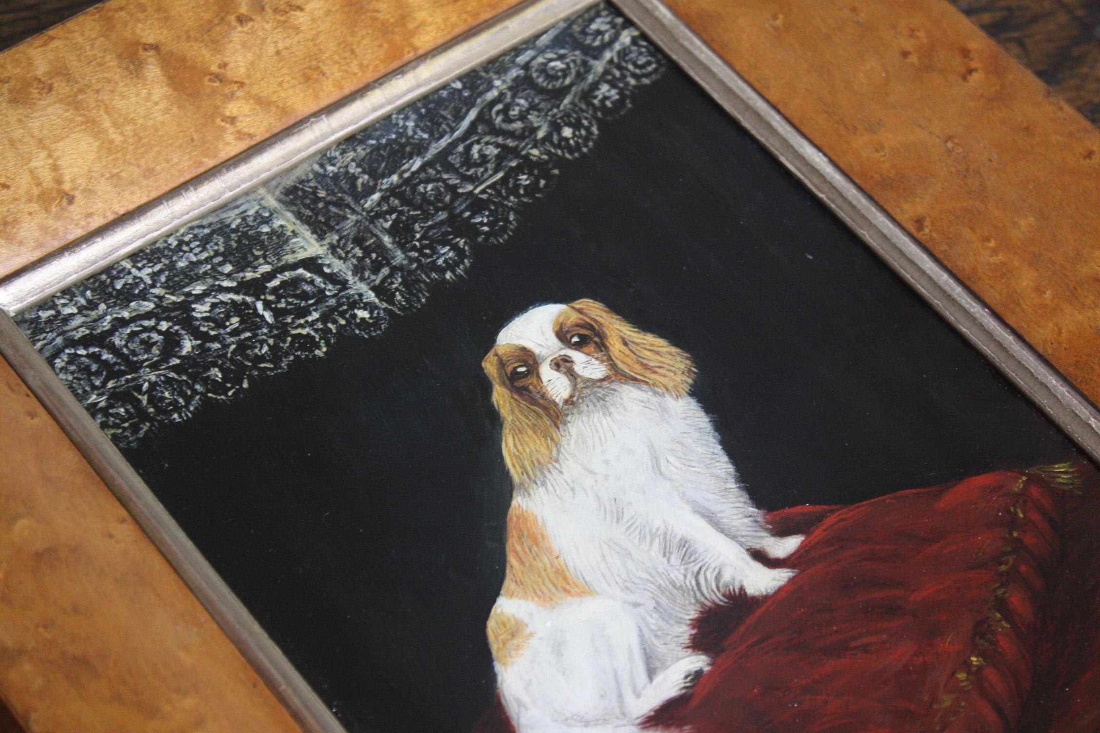 A charming oil on canvas of a Cavalier King Charles Spaniel on a large crimson velvet cushion 

set later in a period burr maple veneered frame with gold slip 

dated 1904 and signed bottom left T L M 

29cm by 25cm.