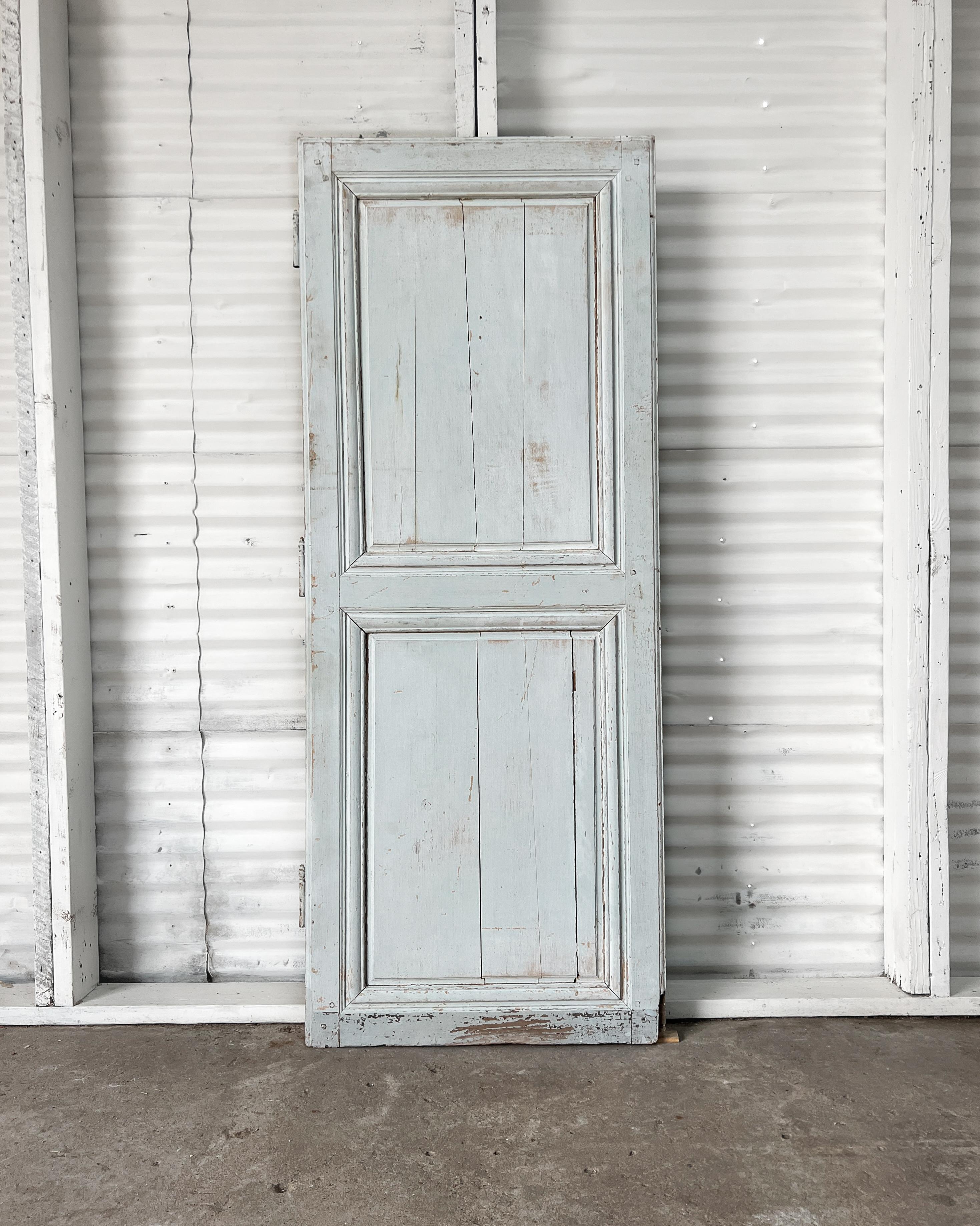 19th-century 2-panel French door with raised panels and grooved beveled trim detailing. Install in a new home to enclose a pantry or linen cupboard to instantly add a layer of charm and character that can’t be replicated with modern mass-produced