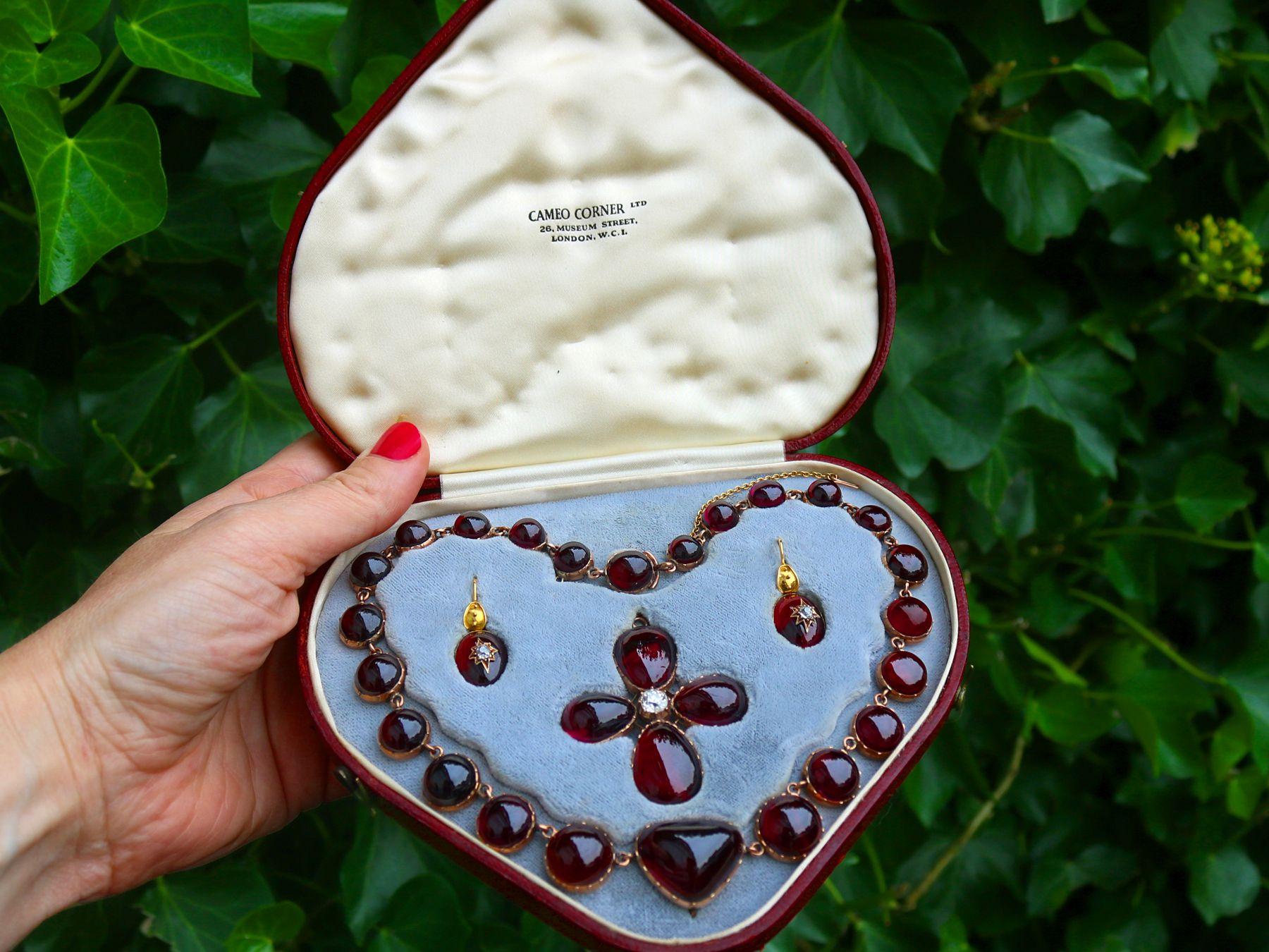 A stunning antique 1820s Regency era 206.60 carat garnet and 1.49 carat diamond, 8k and 9k yellow gold jewelry set; part of our diverse antique jewelry and estate jewelry collections.

This stunning, fine and impressive Regency era cabochon cut