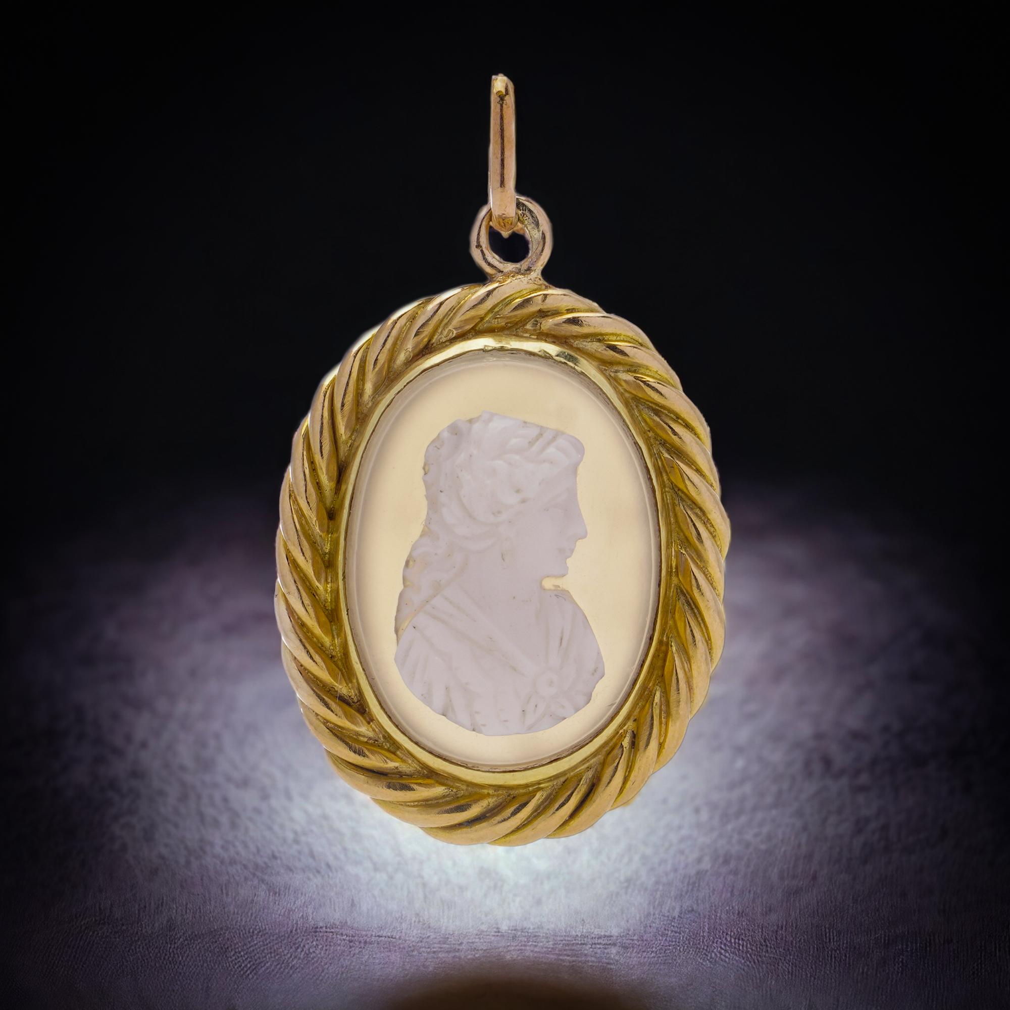A 19th-century pendant crafted from intricately carved shell and chalcedony, elegantly set in 20kt yellow gold. This pendant showcases a delicately carved shell cameo depicting the profile of a woman, facing to the right.

Made circa 1860's 
X-Ray