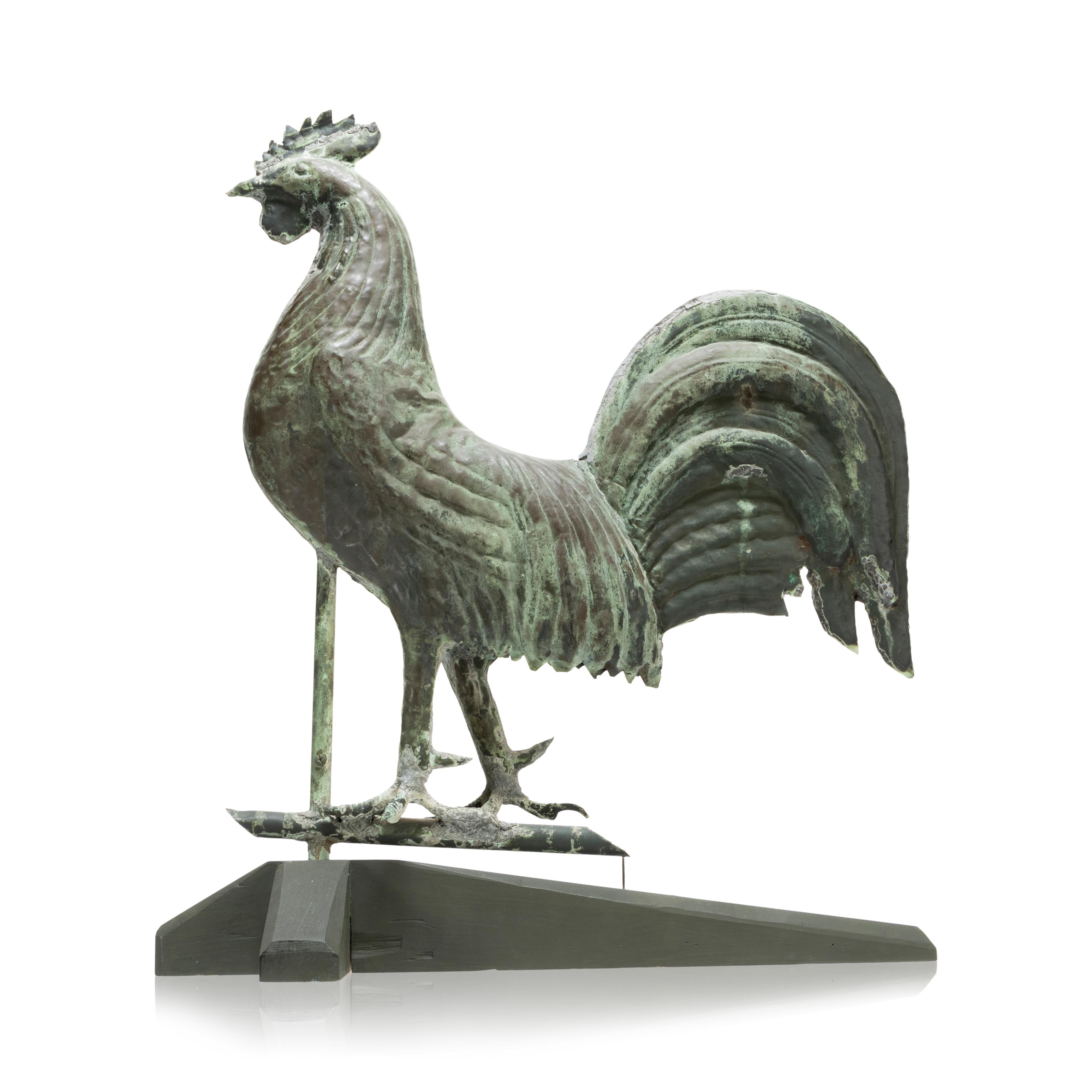Molded sheet copper rooster weather vane. Flattened full bodied form with molded body and feather details. Large tail with custom wood stand. 20