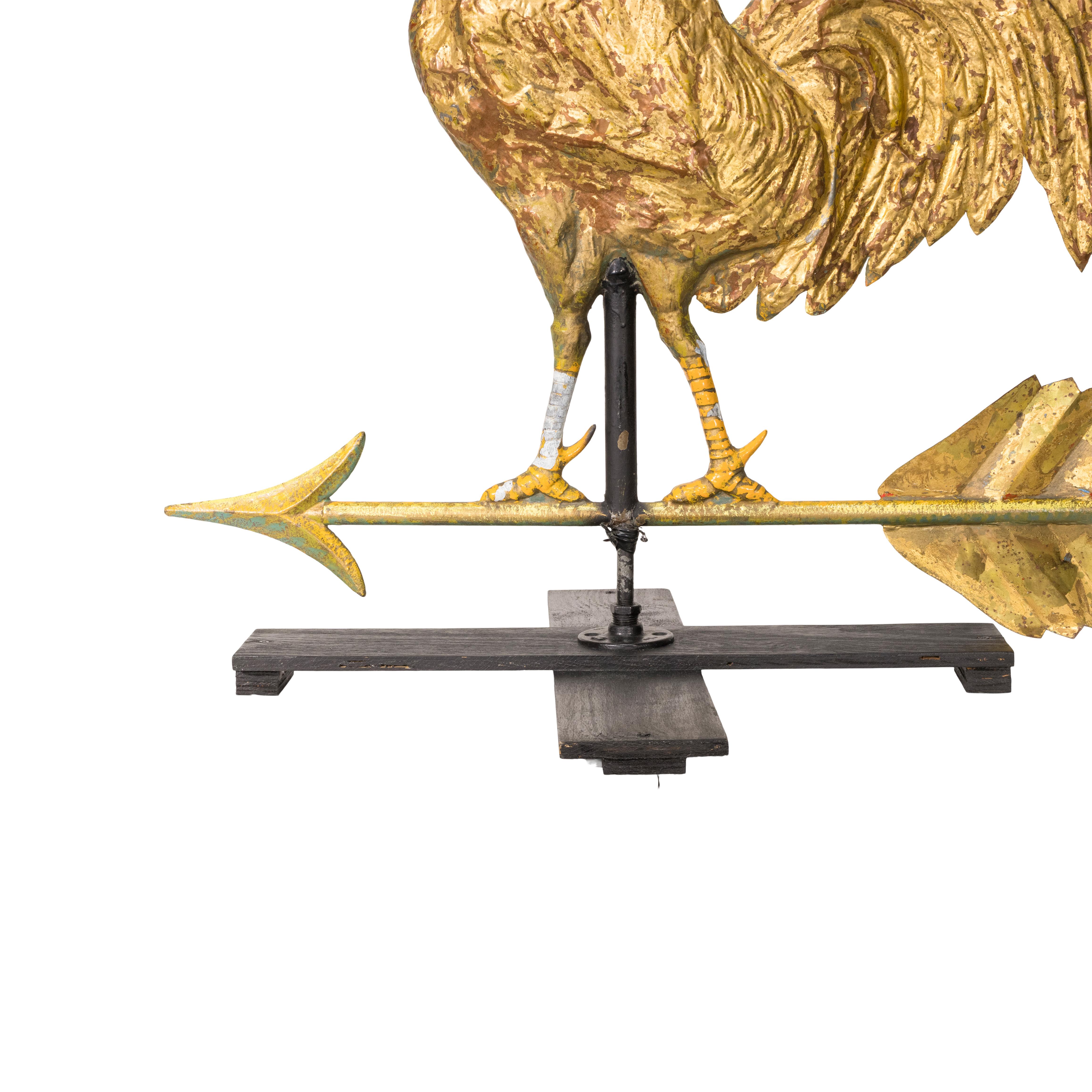 Three dimensional copper rooster weather vane on directional arrow. Mounted on base. Multiple coats of paint with gold gilding. Larger than most.

Period: 19th century
Origin: Ohio, US
Size: 34