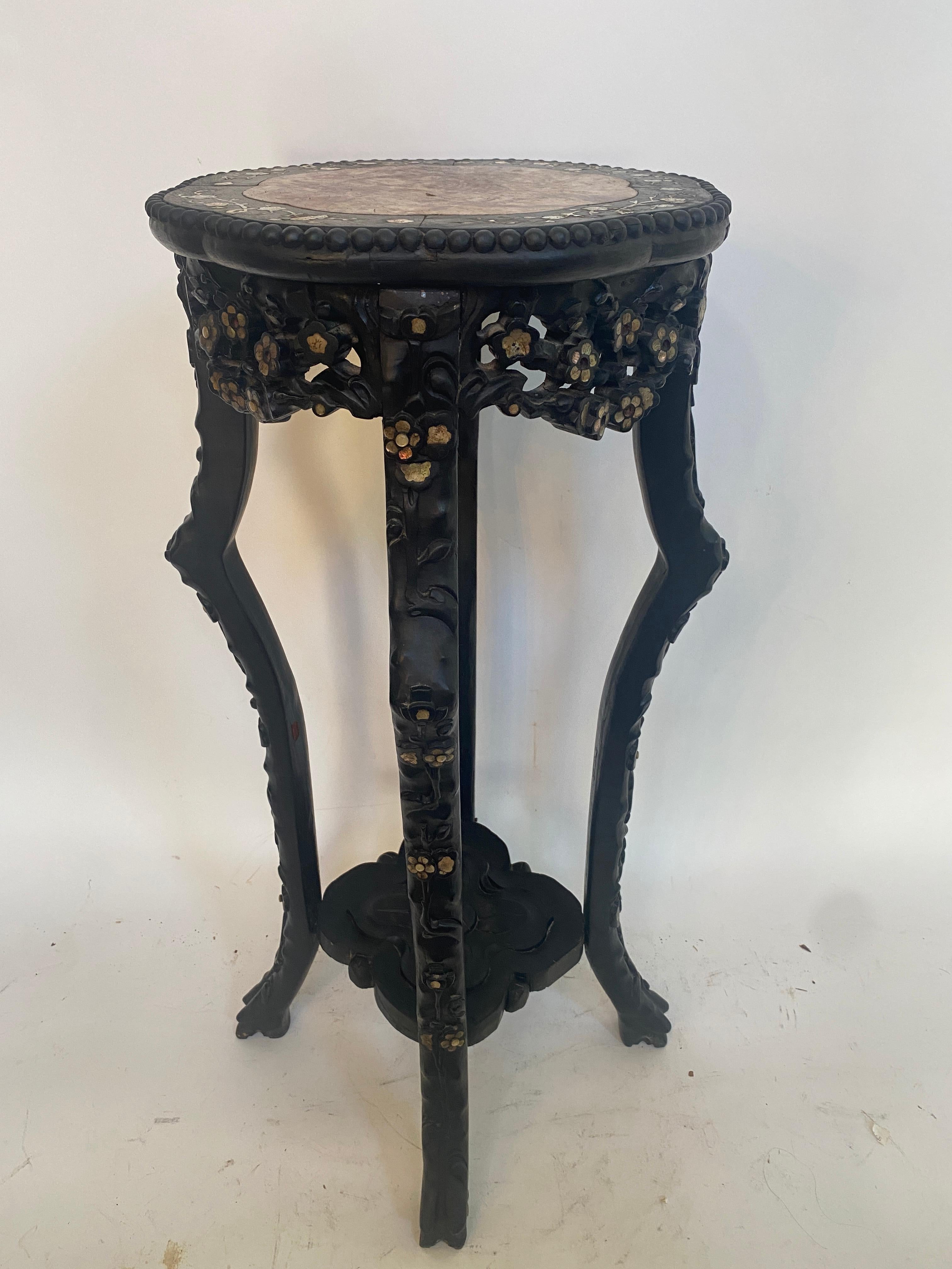 A 19th century antique Chinese heavily carved hardwood circular stand table with rouge marble top insert, the inset marble top over carved hardwood apron with mother of pear inlay plum blossom design and unique 4 legs, see more pictures, measures: