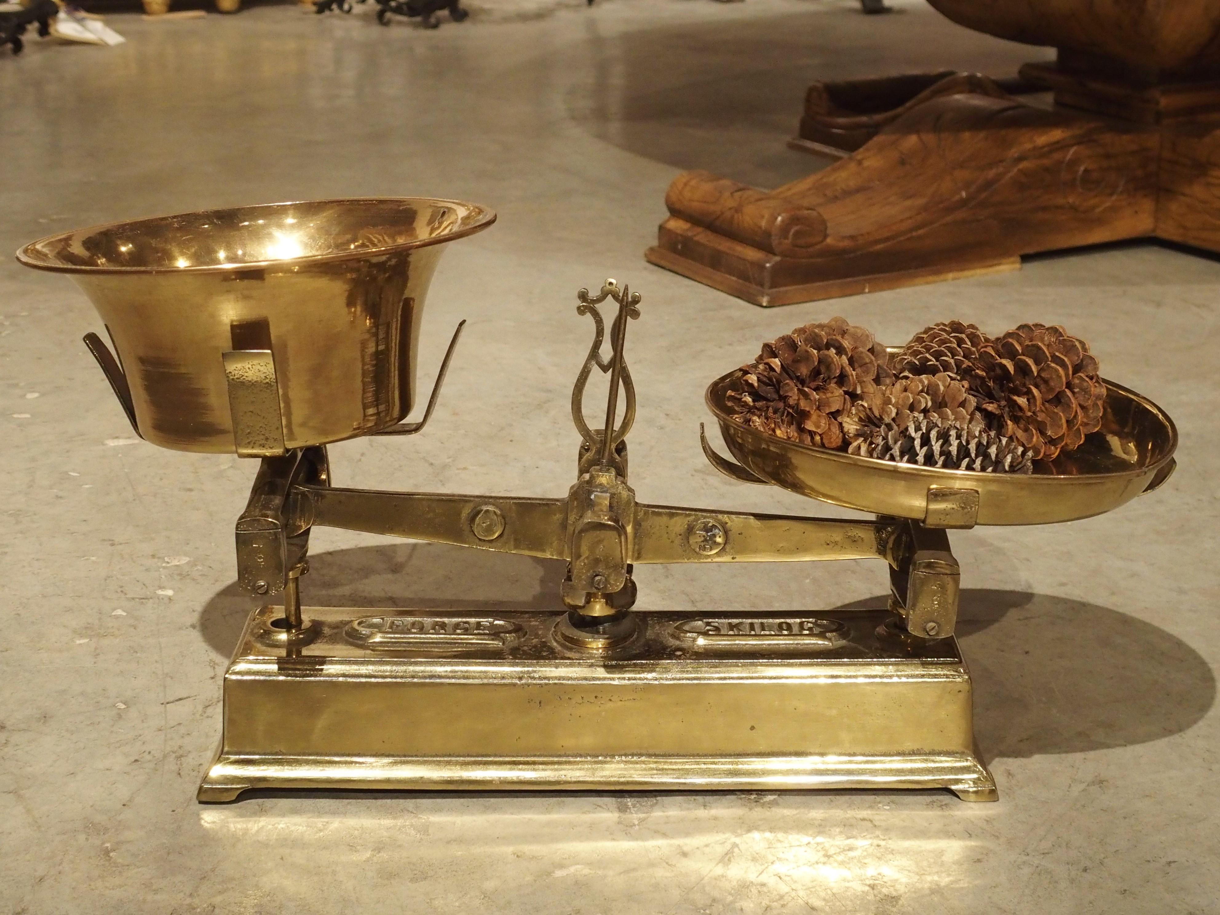 Made from iron and brass, this 5-kilogram scale comes from France during the 1800’s. French scales of this type were used in stores for weighing produce. The cast iron base has two marks underneath the scale arms. The imprint on the left says