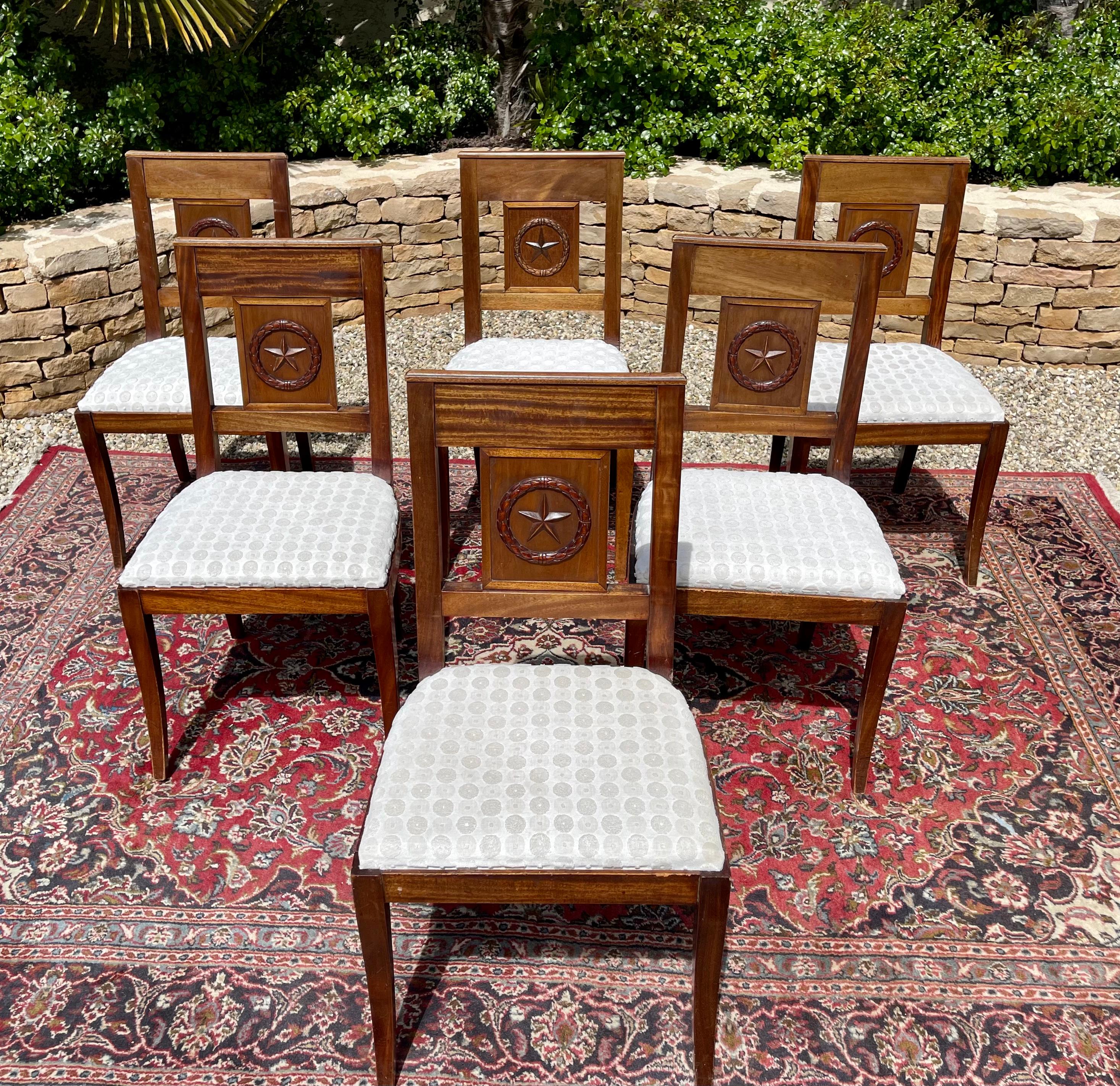 Suite of 6 Directoire style mahogany chairs. The seats are covered with a fabric. They are in good condition.