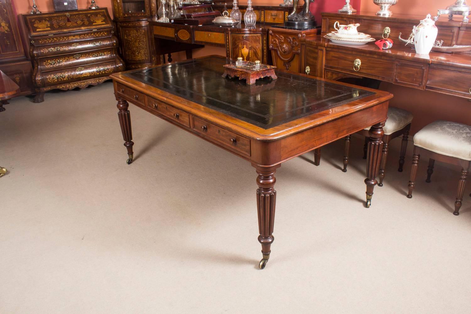 This gorgeous early Victorian antique Partners desk is crafted from beautiful flame mahogany and dates from circa 1860.

It features a striking dark olive green leather top that has beautiful hand tooled impressed decoration. It is raised on four
