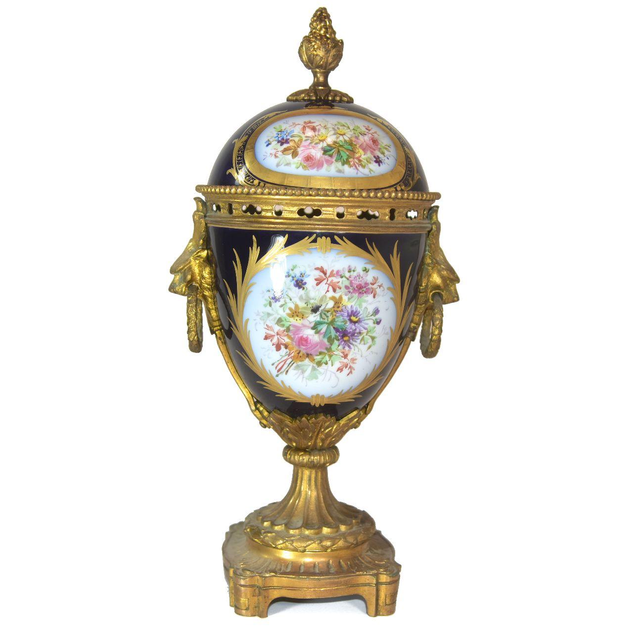 19th century a cup in gilt bronze and Sèvres Porcelain mount in gilt bronze with a height dimension of 32 cm.