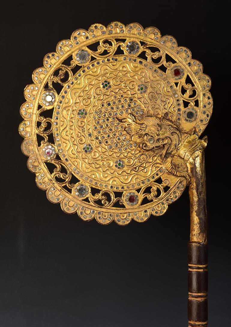 A pair of Burmese wooden fans with gilded gold and glass.

Age: Burma, Mandalay Period, 19th Century
Size: Height 98.8 - 100 C.M. / Width 29.3 - 29.8 C.M. / Height including stand 108.8 - 110 C.M. 
Condition: Nice condition overall (some