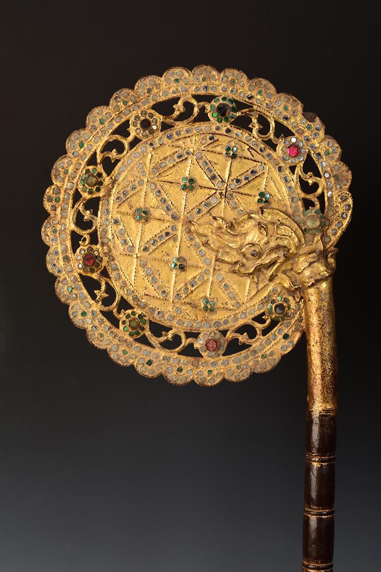 A pair of Burmese wooden fans with gilded gold and glass.

Age: Burma, Mandalay Period, 19th Century
Size: Height 80.5 - 81.5 C.M. / Width 25.3 - 25.4 C.M.
Size including stand: 90.5 - 91.5 C.M.
Condition: Nice condition overall (some expected