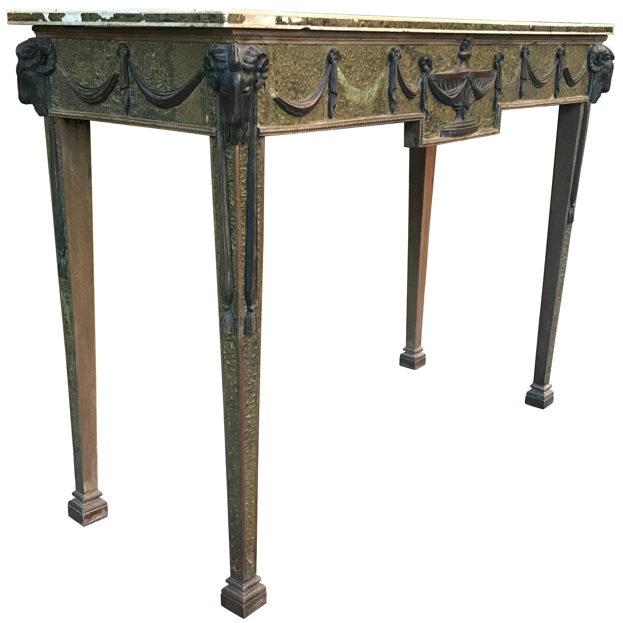 An unbelievably sophisticated yet approachable rare 19th century Adam style console table with scagliola finish and wood goat head, urn, and swag applied decorations. The top is marble with neoclassical etched Greek Key pattern with more inlaid