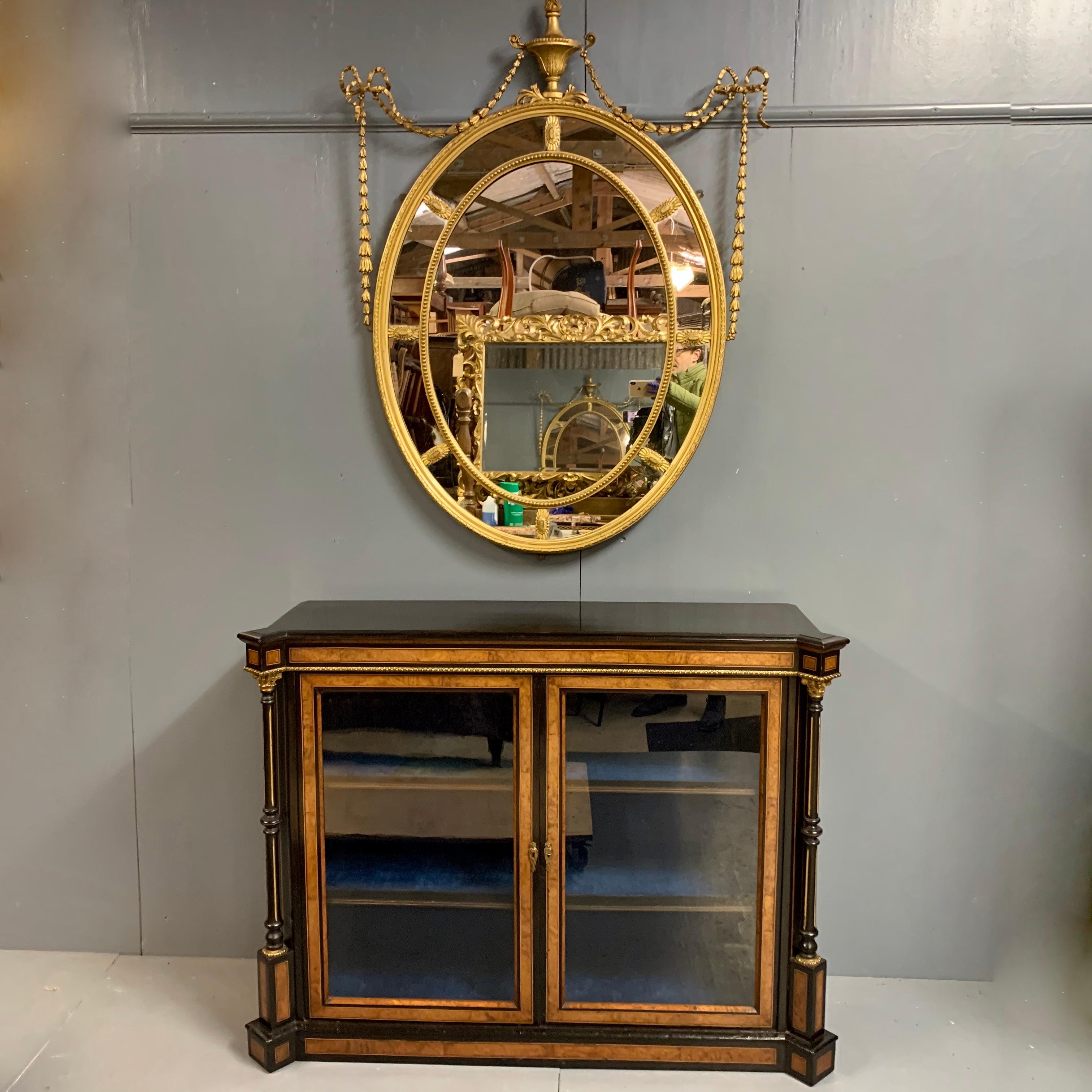 A very beautiful and impressive size 19th century gilt Adams style oval mirror with decorative urn and ribbon tied swags.
This is a lovely quality mirror and in great condition with only a few very minor restorations required (all done for you of