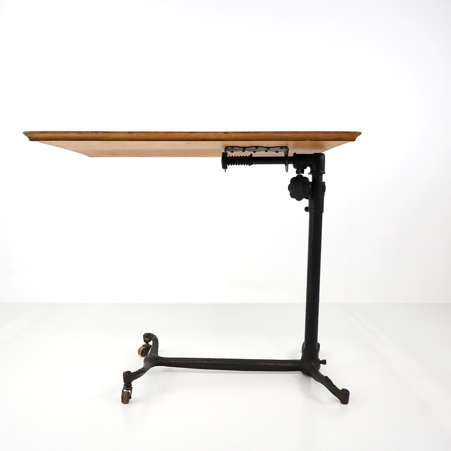 We offer this 19th century adjustable drafting table in cast iron. The top of the table are original and made in solid oak, supported by a finely cast iron base. The height is adjusted from 59 cm too 89 cm.