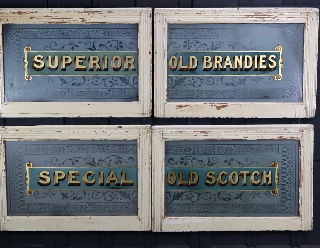 Beautifully detailed, etched glass advertising windows with a central, reverse painted advertising panel displaying the drinks that were available from an old London tavern.
The two panels read 