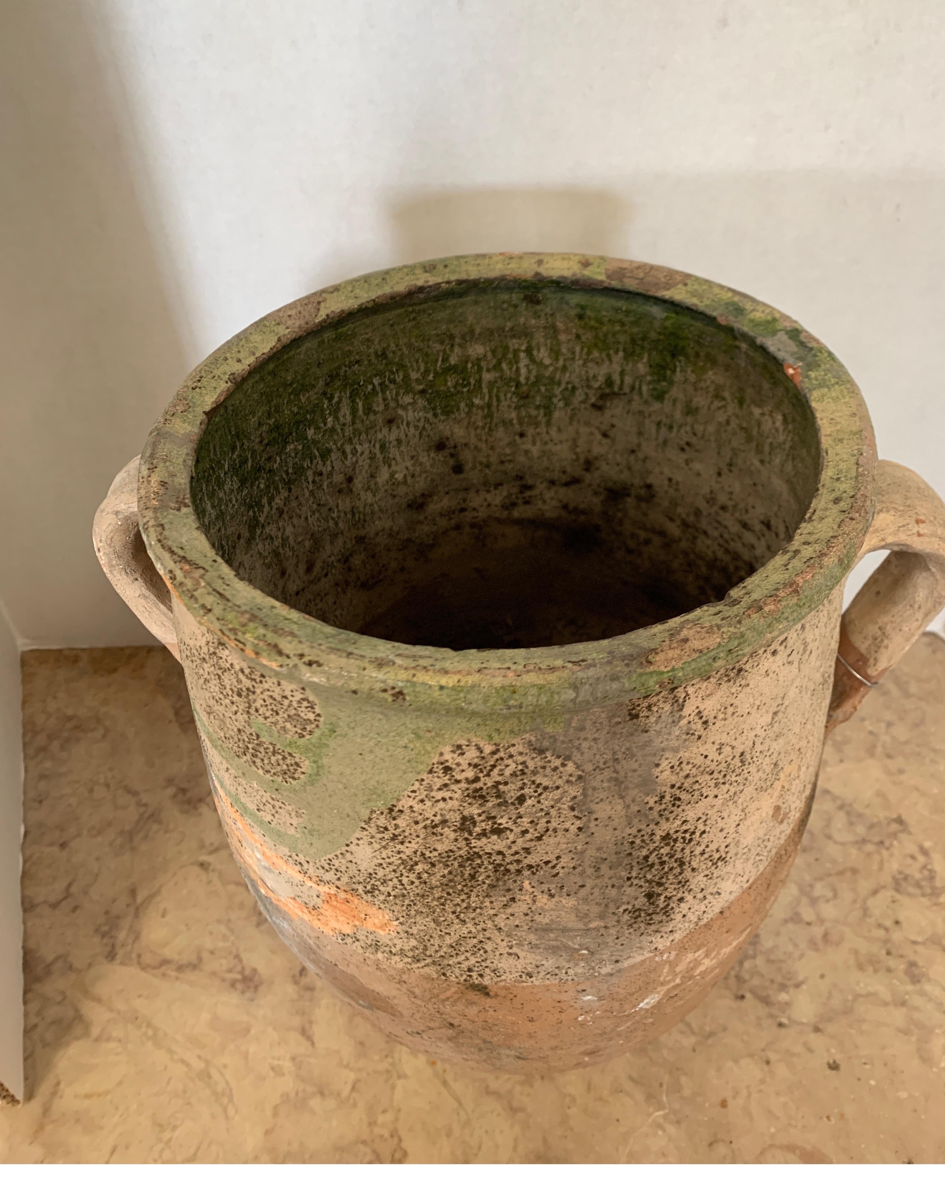 This is a Turkish double handle vessel that make a great addition to any style of decoration. It’s got beautiful patina and glazed green on top.
It measures 12“ W x 8 5/8 D x 12 5/8 T.